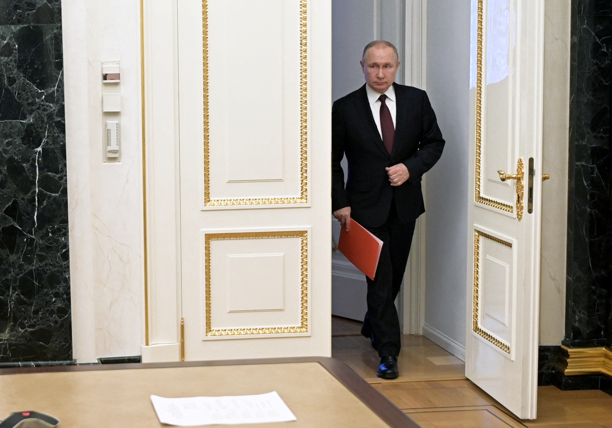 Russian President Vladimir Putin enters a hall before a meeting with members of the Security Council via a video link in Moscow, Russia February 25, 2022. Sputnik/Alexey Nikolsky/Kremlin via REUTERS ATTENTION EDITORS - THIS IMAGE WAS PROVIDED BY A THIRD PARTY.