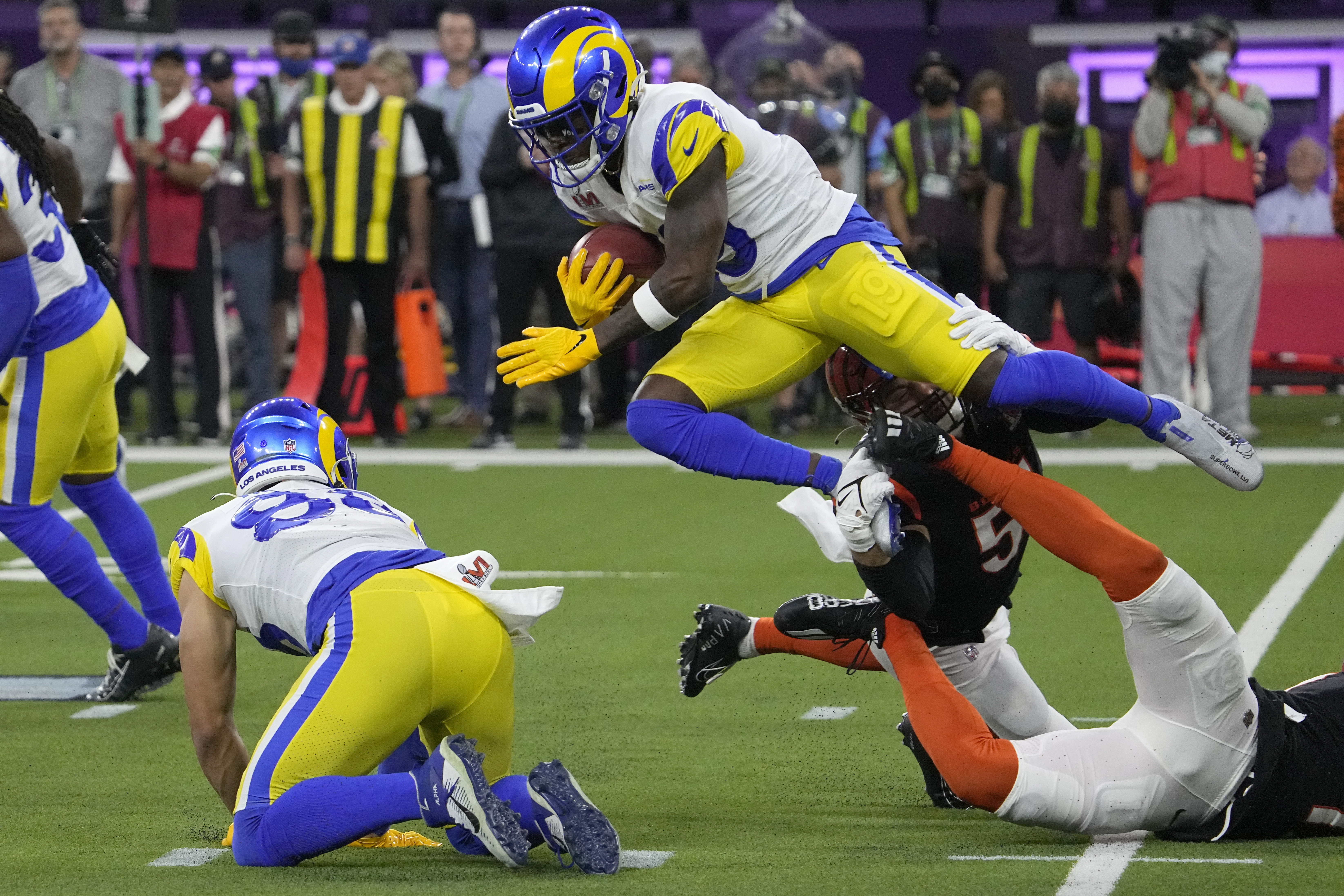 Los Angeles Rams wide receiver Brandon Powell, top, leaps over Cincinnati Bengals defenders during the second half