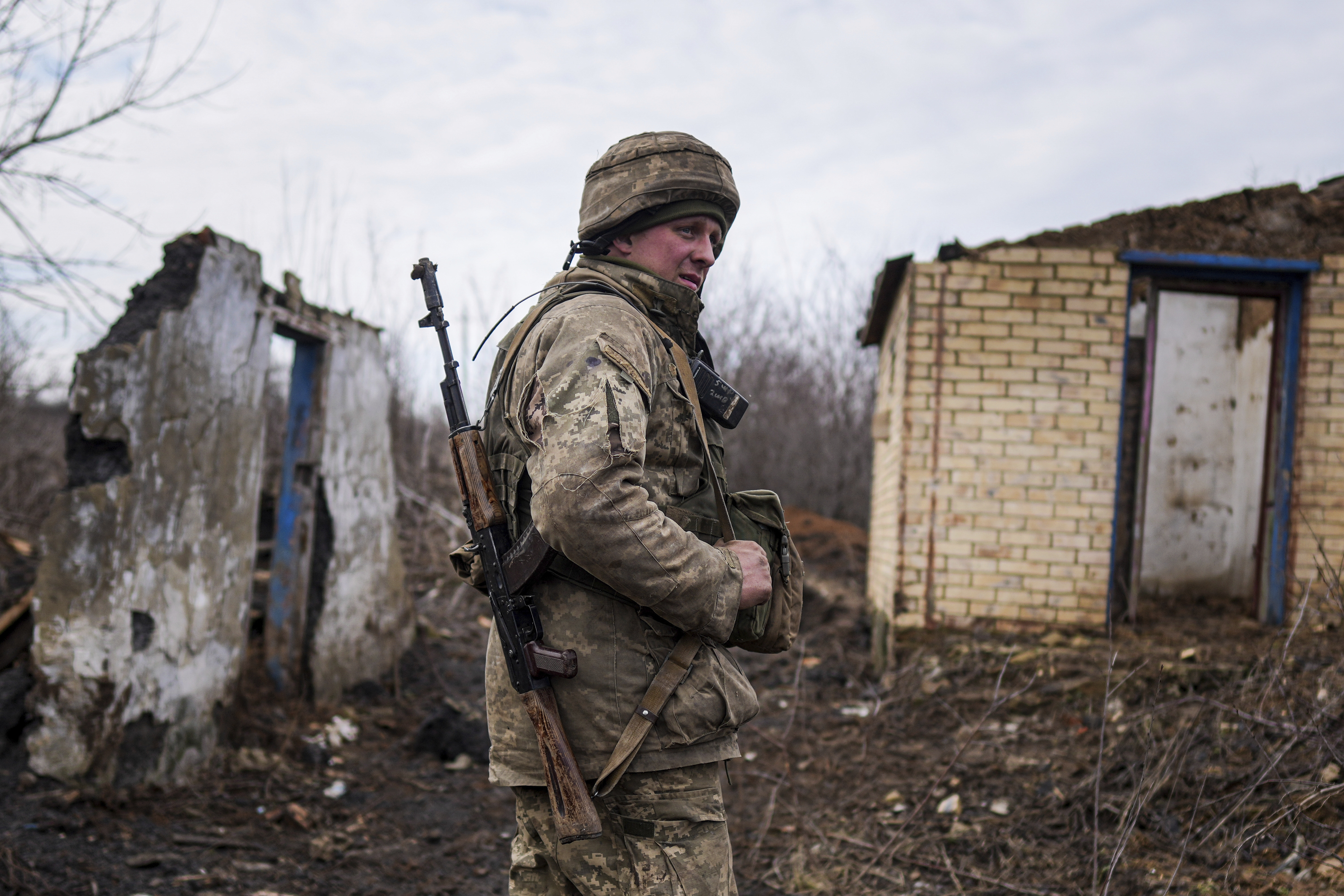 A Ukrainian serviceman stands at his position at the line of separation between Ukraine-held territory and rebel-held territory near Svitlodarsk