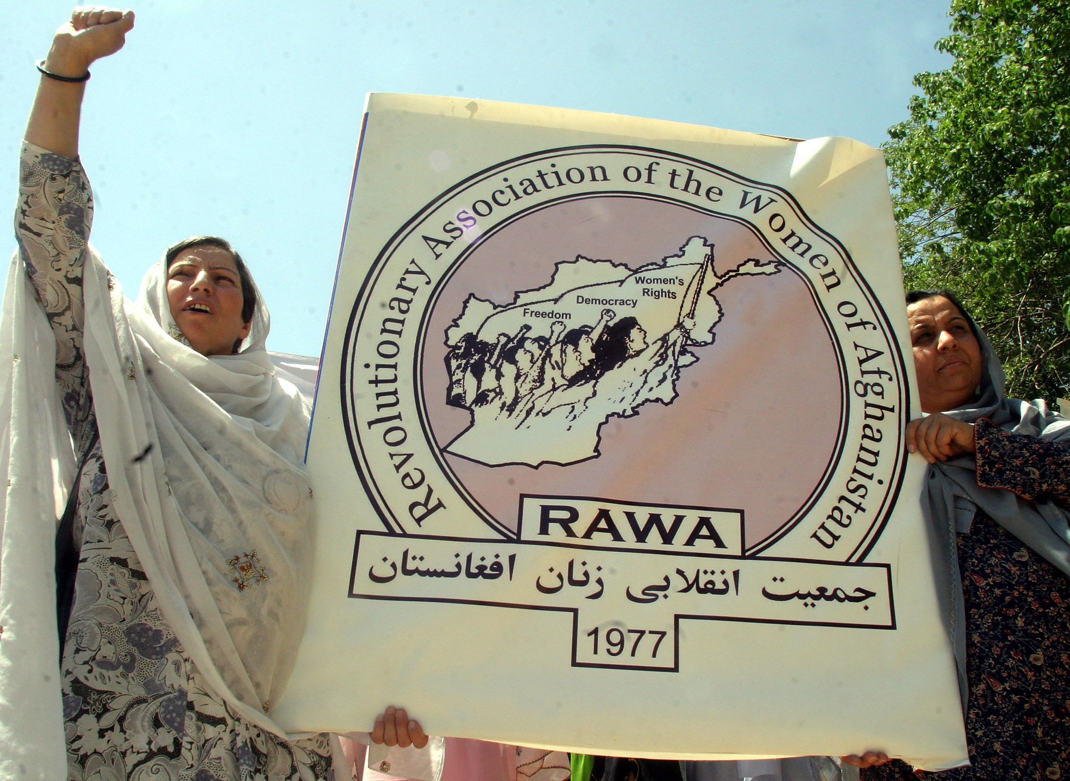 Afghan women hold a banner as they shout anti Afghan government slogans during a demonstration in Islamabad in 2005.