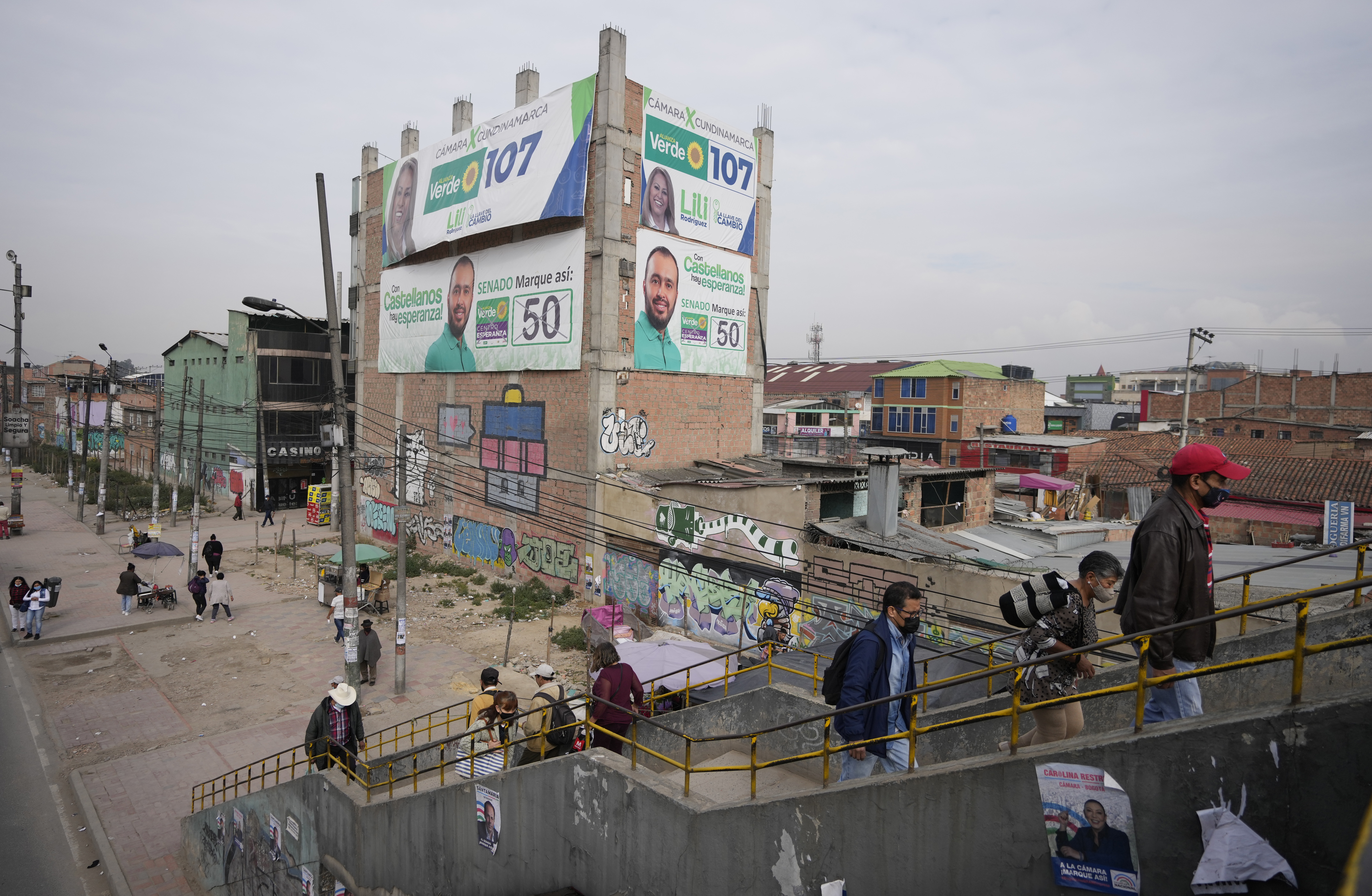 Campaign signs for legislative candidates cover a building in Soacha, Colombia