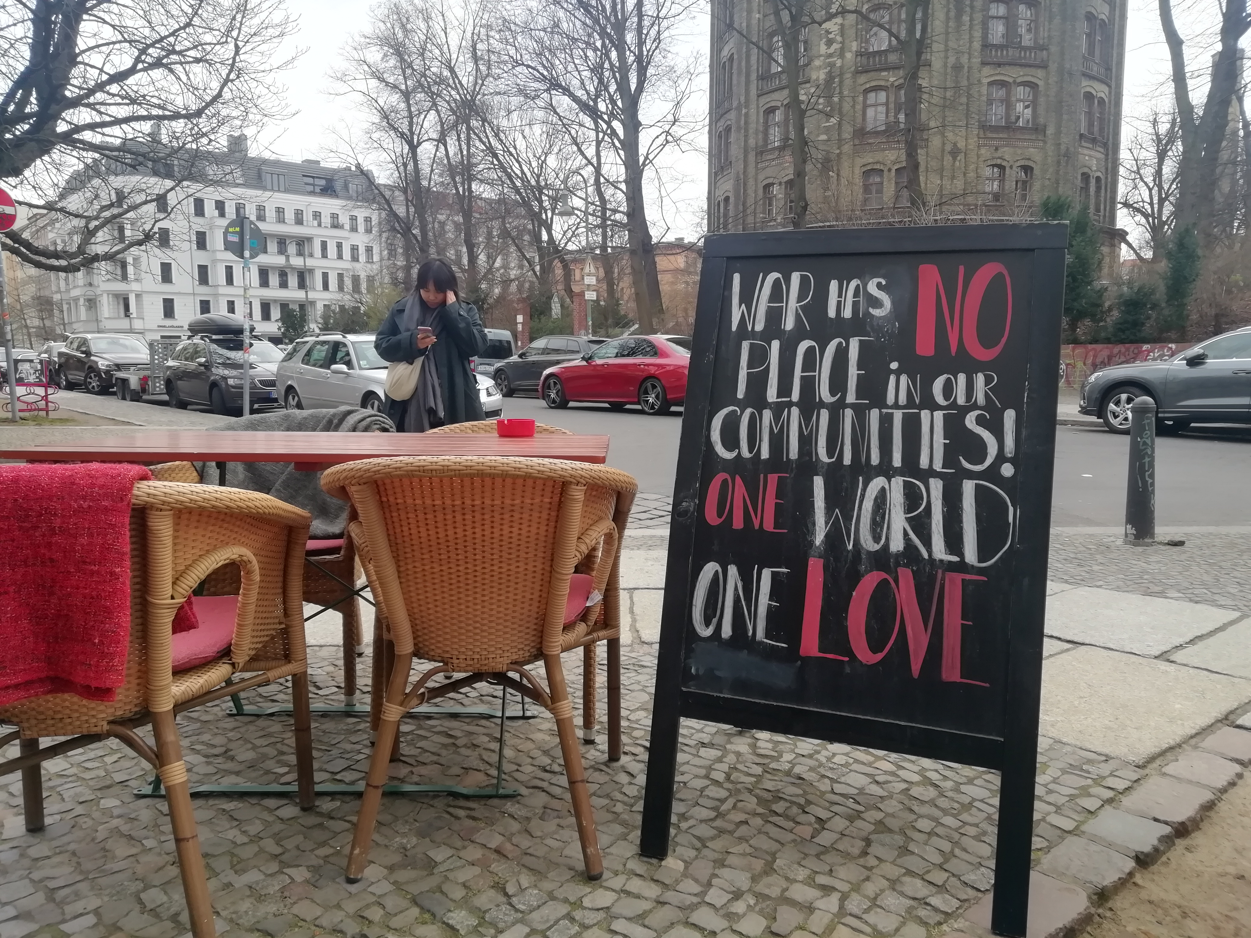 A sandwich board outside a Berlin Russian Jewish restaurant has a message of peace