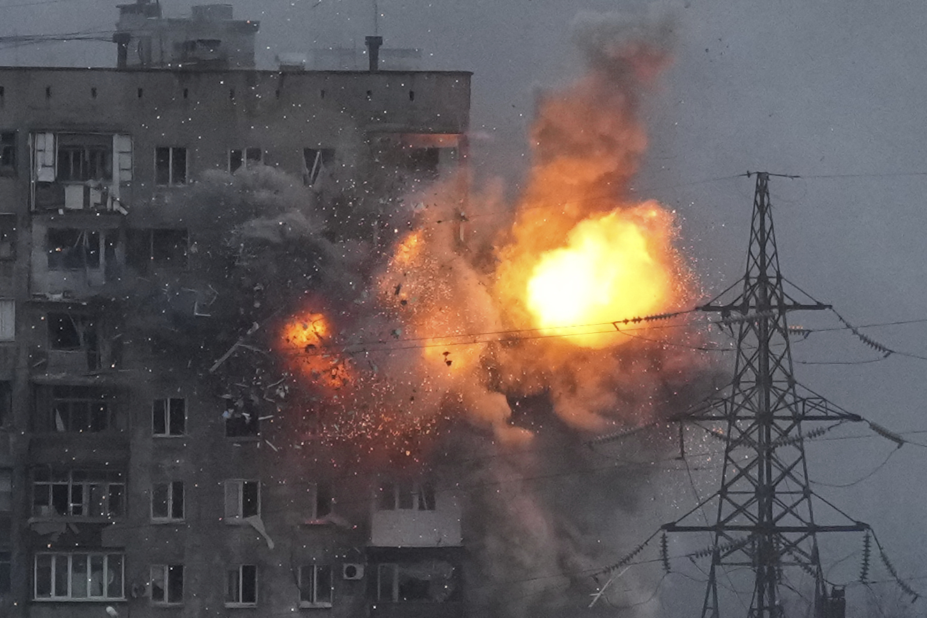 An explosion in an apartment building that came under fire from a Russian army tank in Mariupol