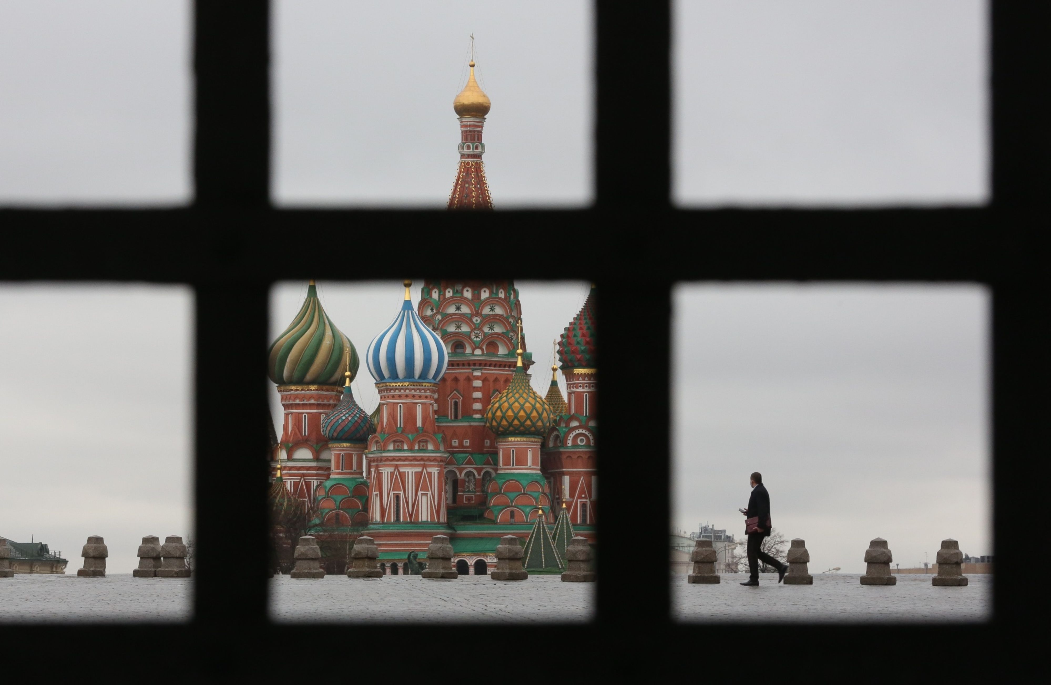 A pedestrian walks in Red Square near the Kremlin in Moscow