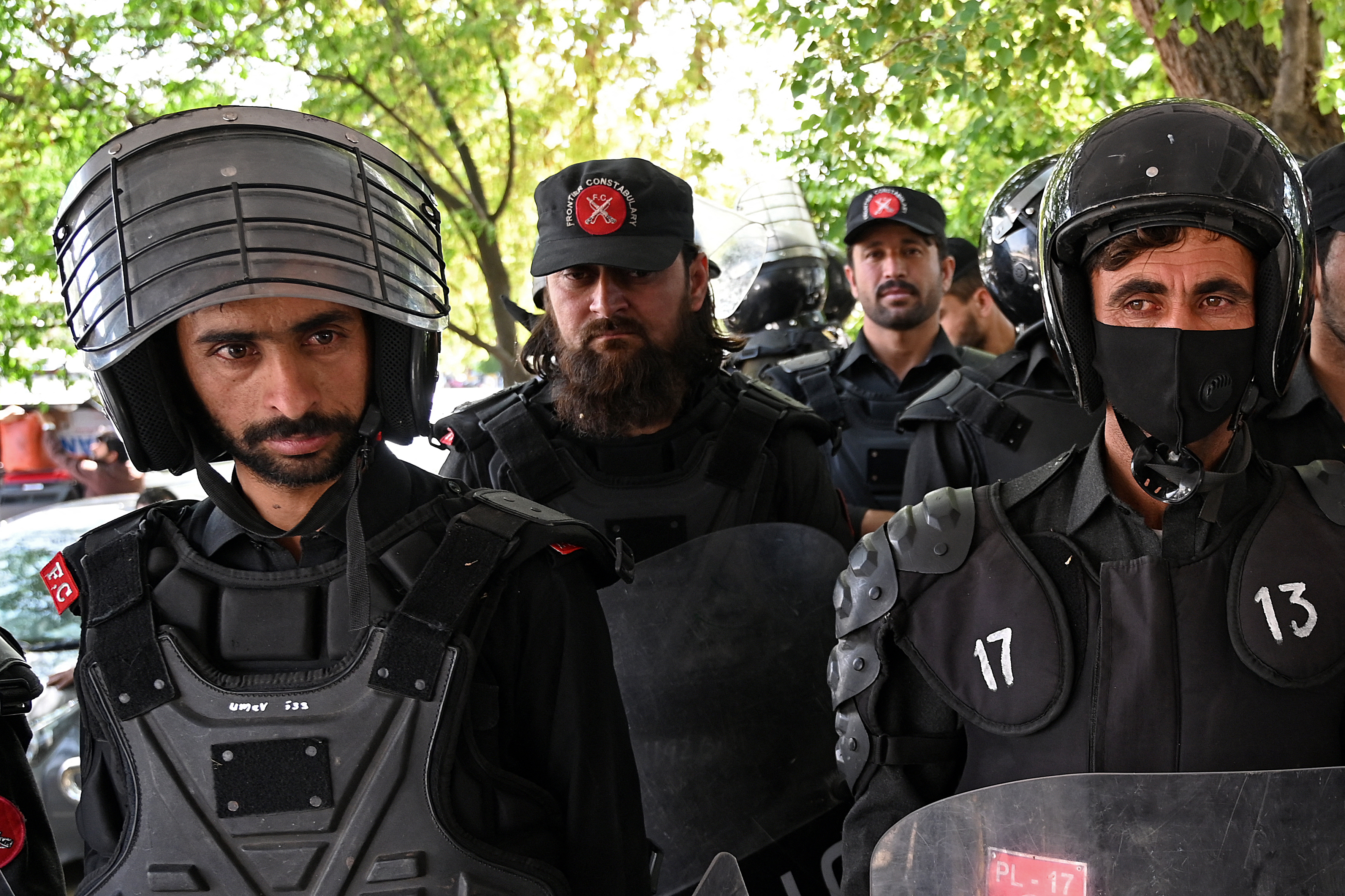 Riot policemen stand guard.