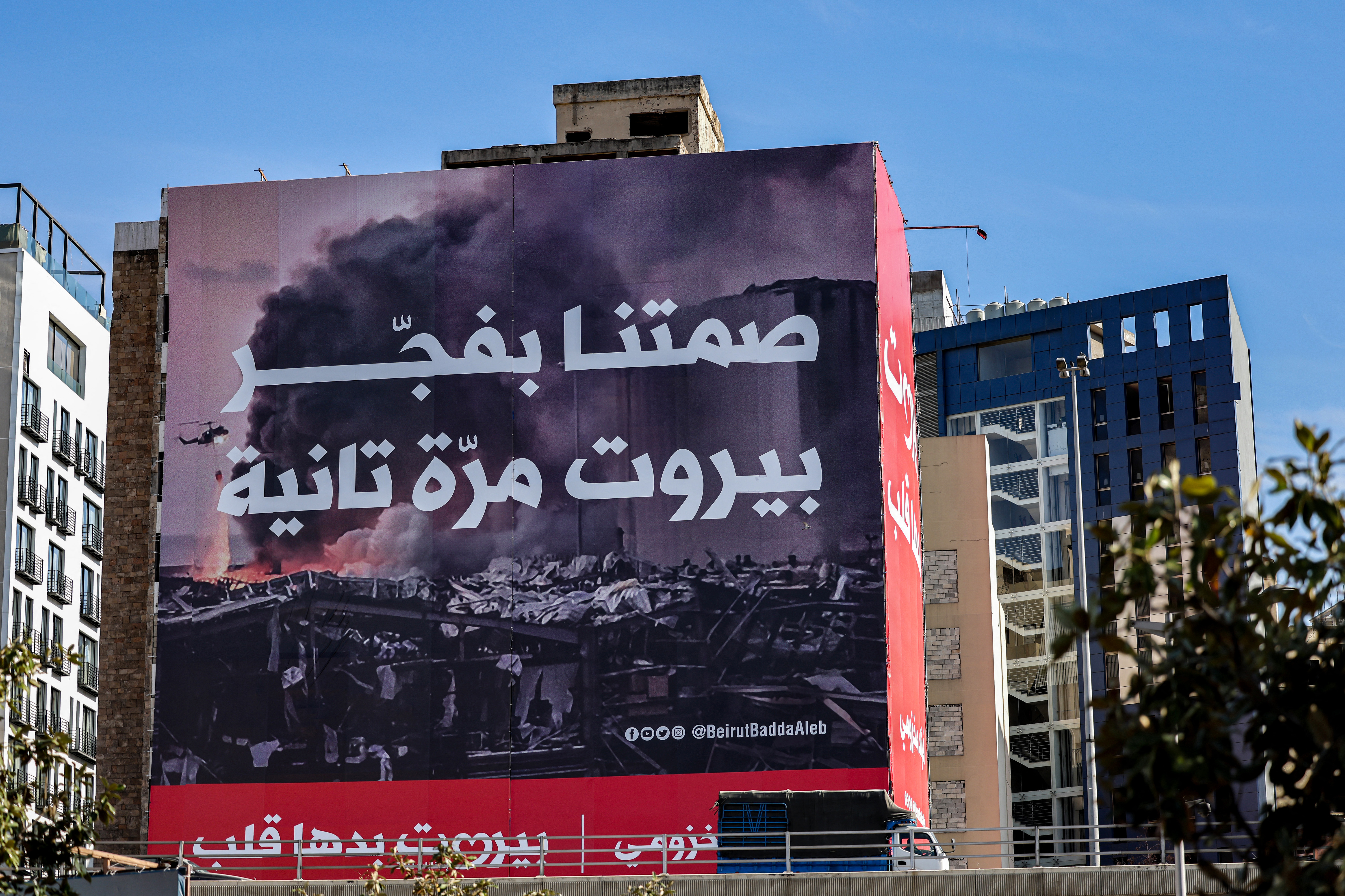 A truck drives past a billboard for the upcoming parliamentary election