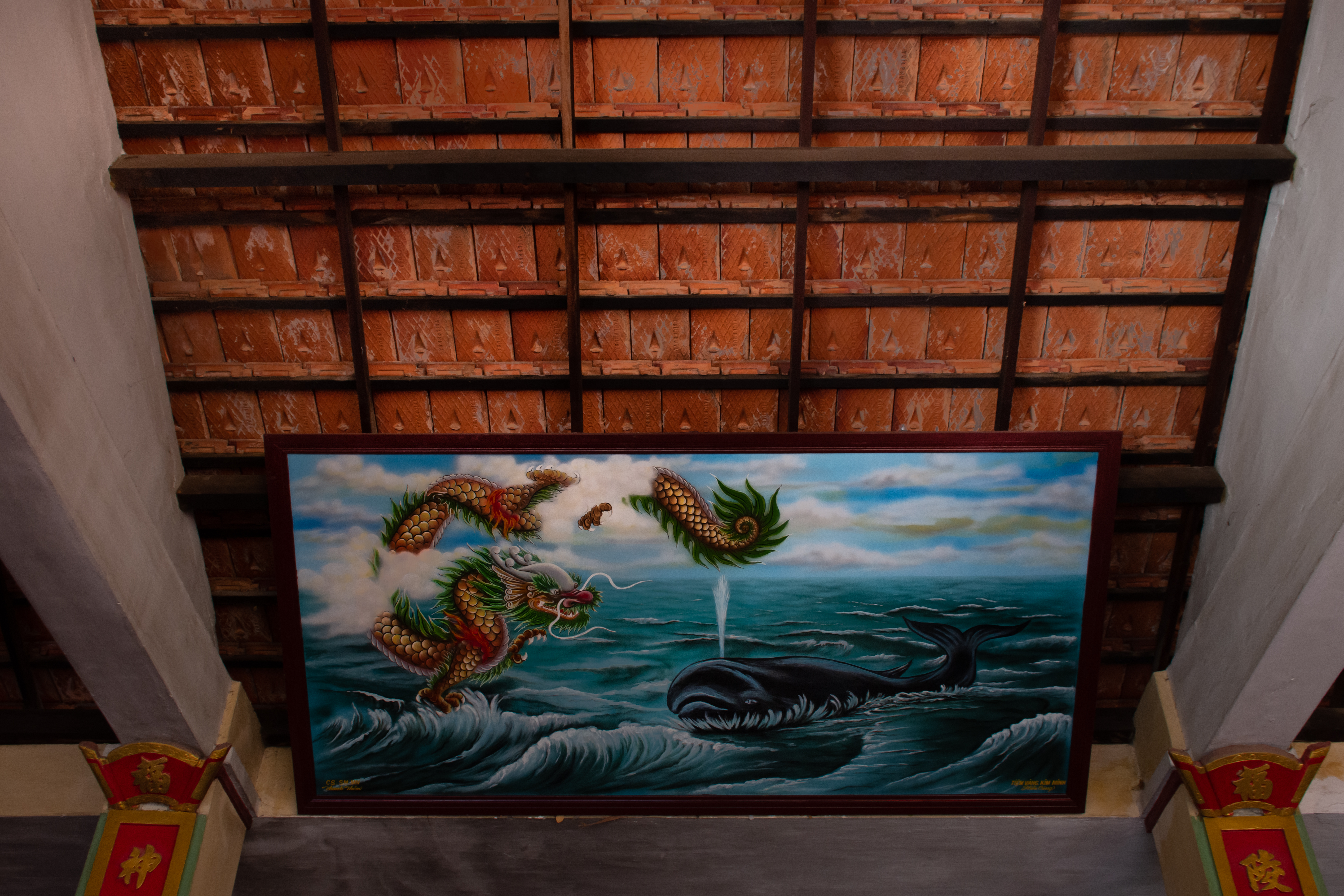 A photo of painting of a great whale and a mythical dragon.
