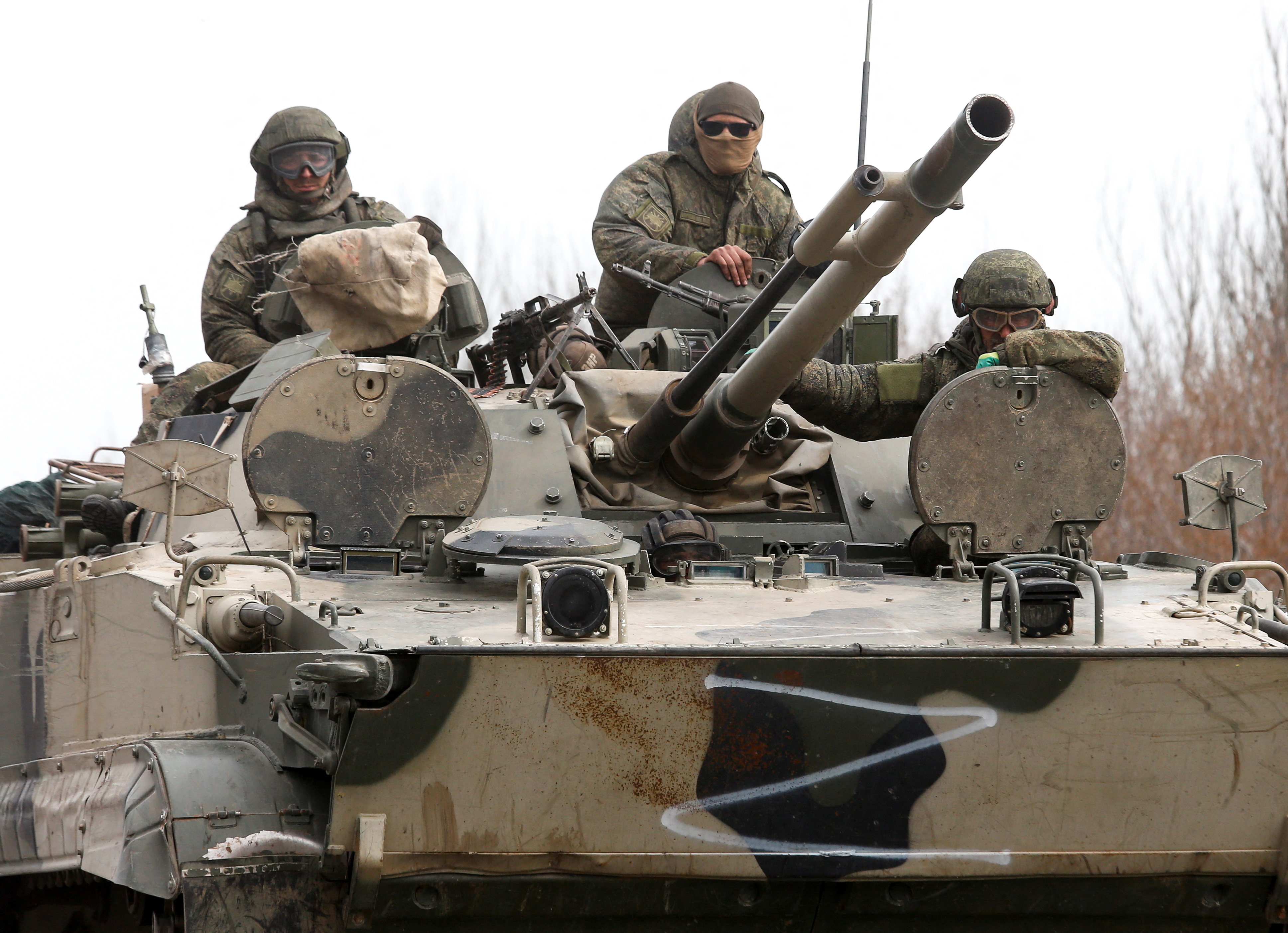 Russian troops drive a tank outside the besieged southern city of Mariupol [Alexander Ermochenko/Reuters]