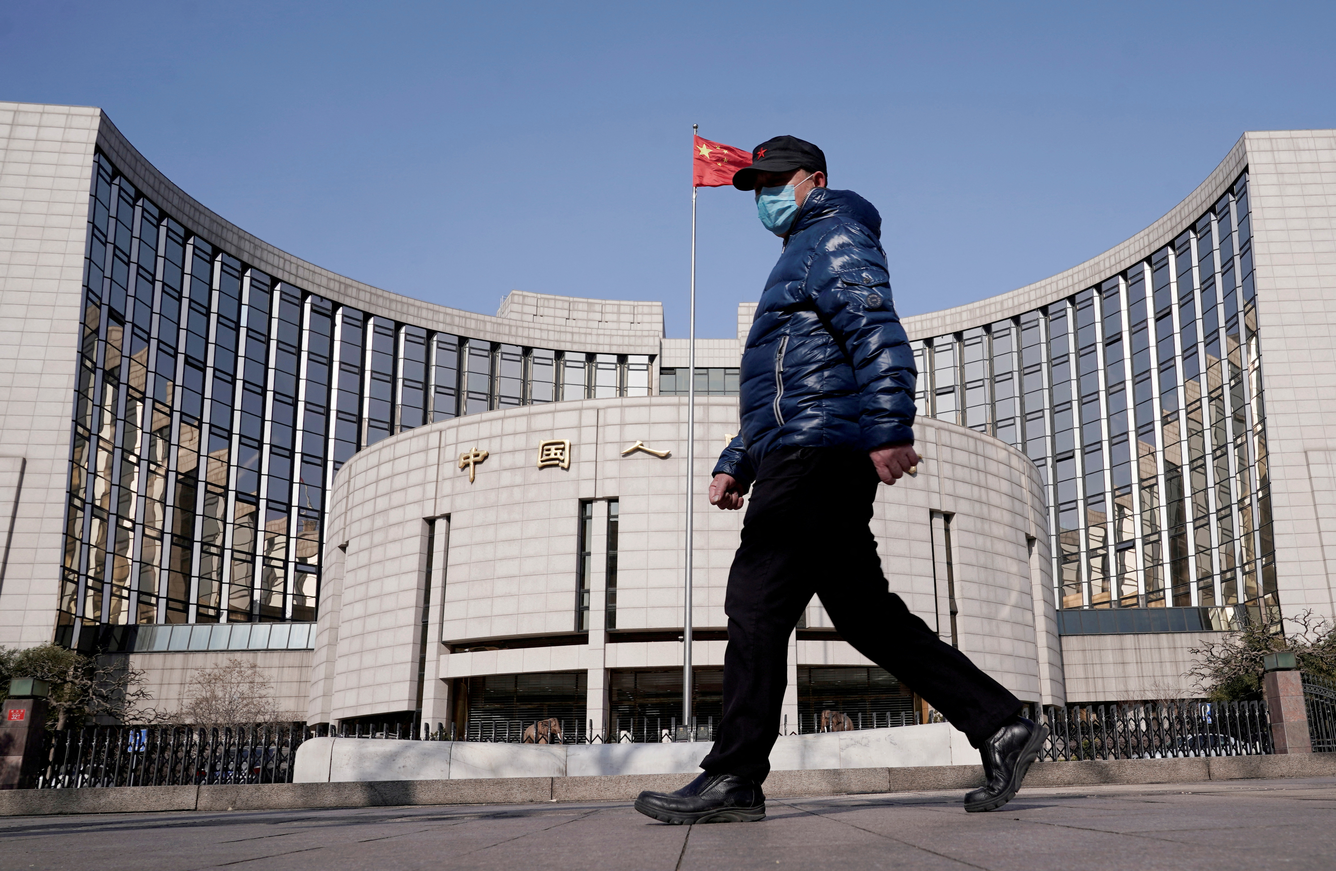A man walks by China's central bank.