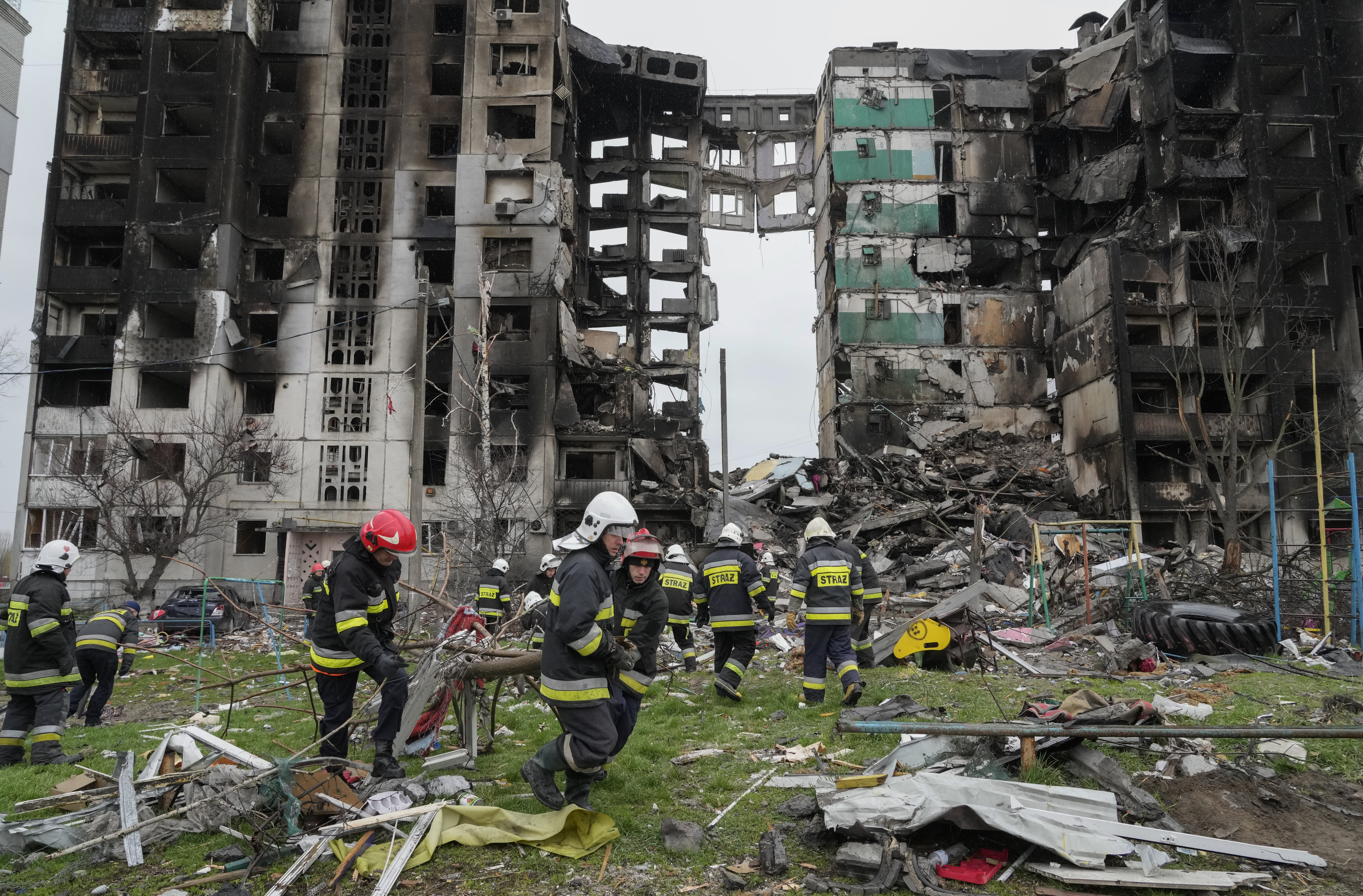 Emergency workers carry debris from a multi-storey building destroyed in a Russian air raid in Borodyanka, close to Kyiv, Ukraine.