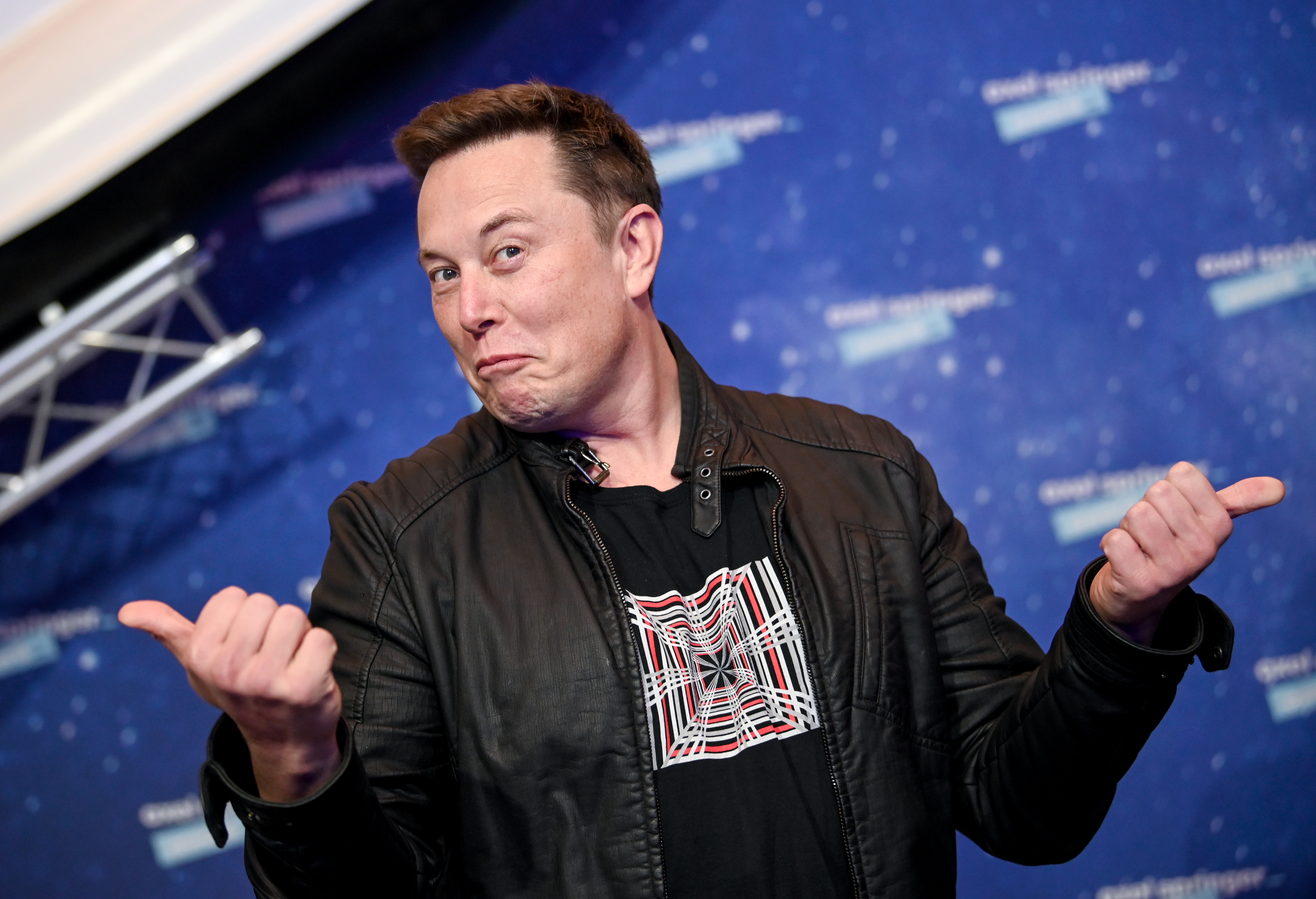 Elon Musk gives two thumbs up on the red carpet of an award show in Berlin, Germany