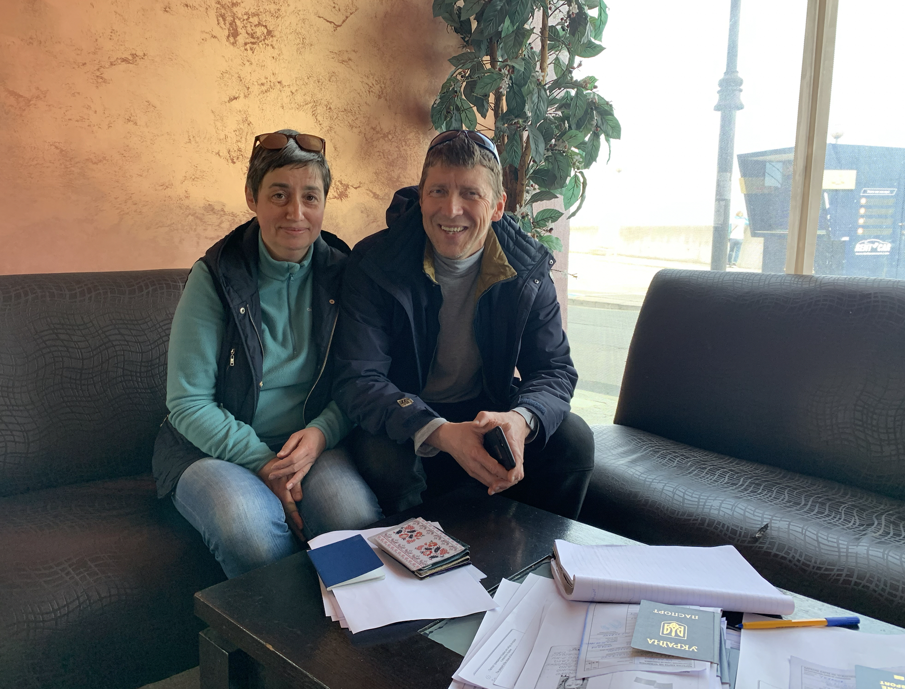 Elena and Mihail Stepanov, Russian nationals living in Bulgaria, are helping Ukrainian refugees register themselves at the Bulgarian police station. [Antoaneta Roussi/Al Jazeera]