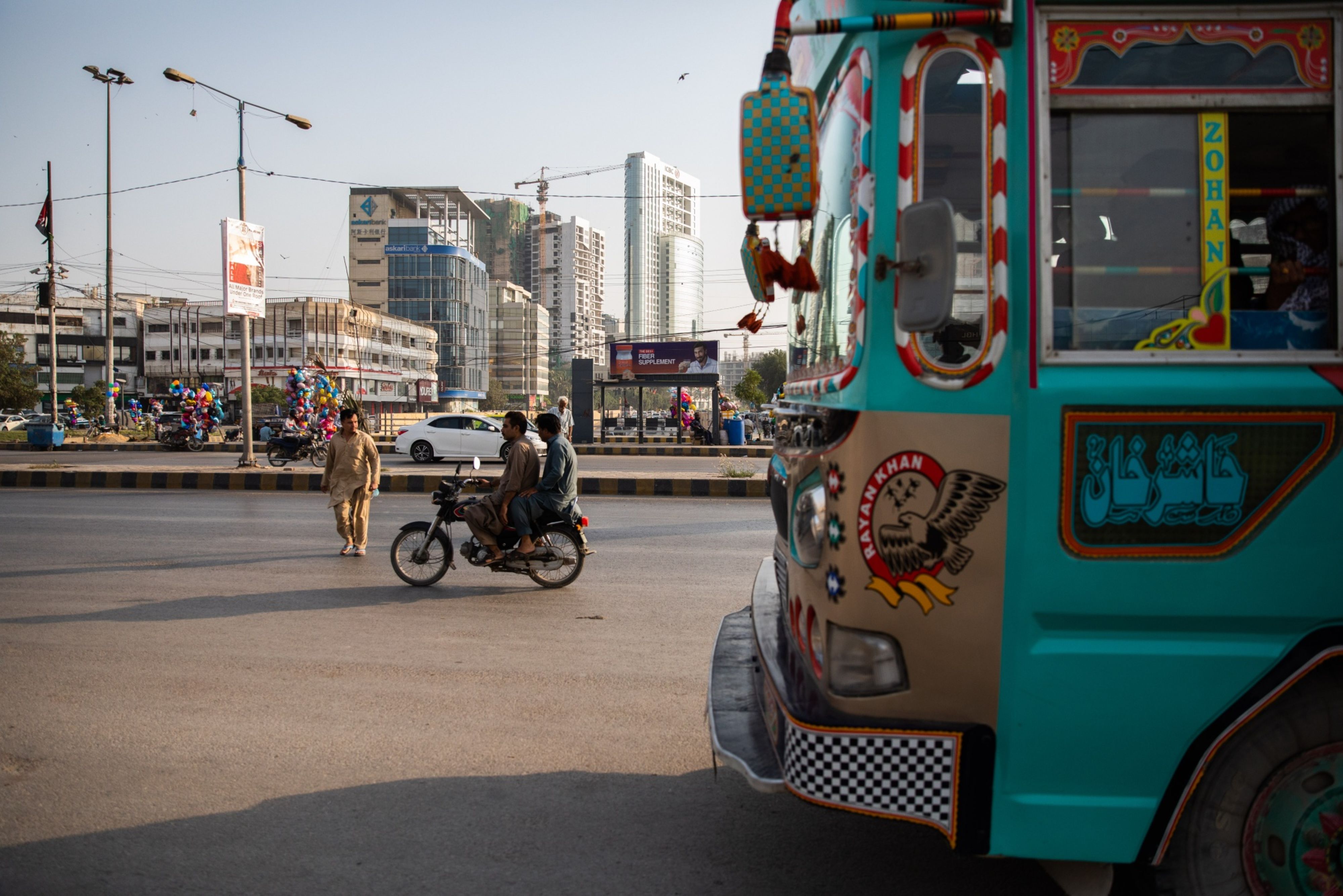 Vehicles drive through a commercial area in Clifton in Karachi, Pakistan