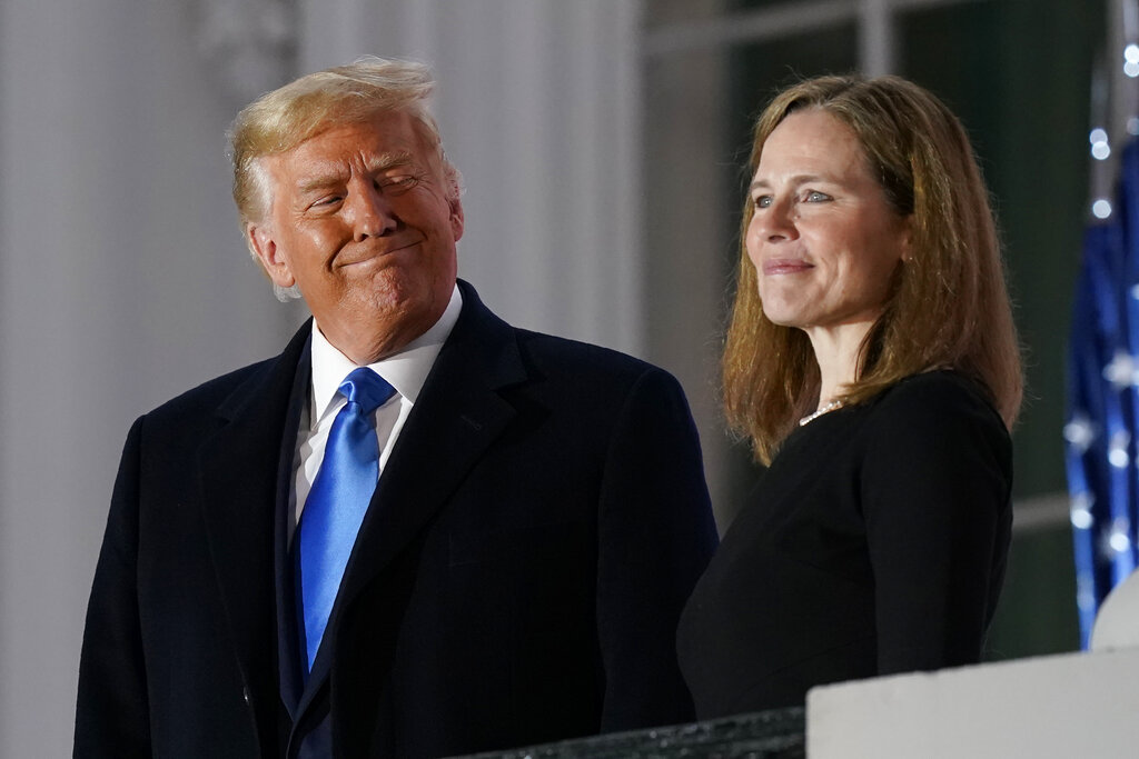 President Donald Trump and Amy Coney Barrett stand on the Blue Room Balcony after Supreme Court Justice Clarence Thomas administered the Constitutional Oath to her on the South Lawn of the White House White House in Washington, Monday, Oct. 26, 2020.