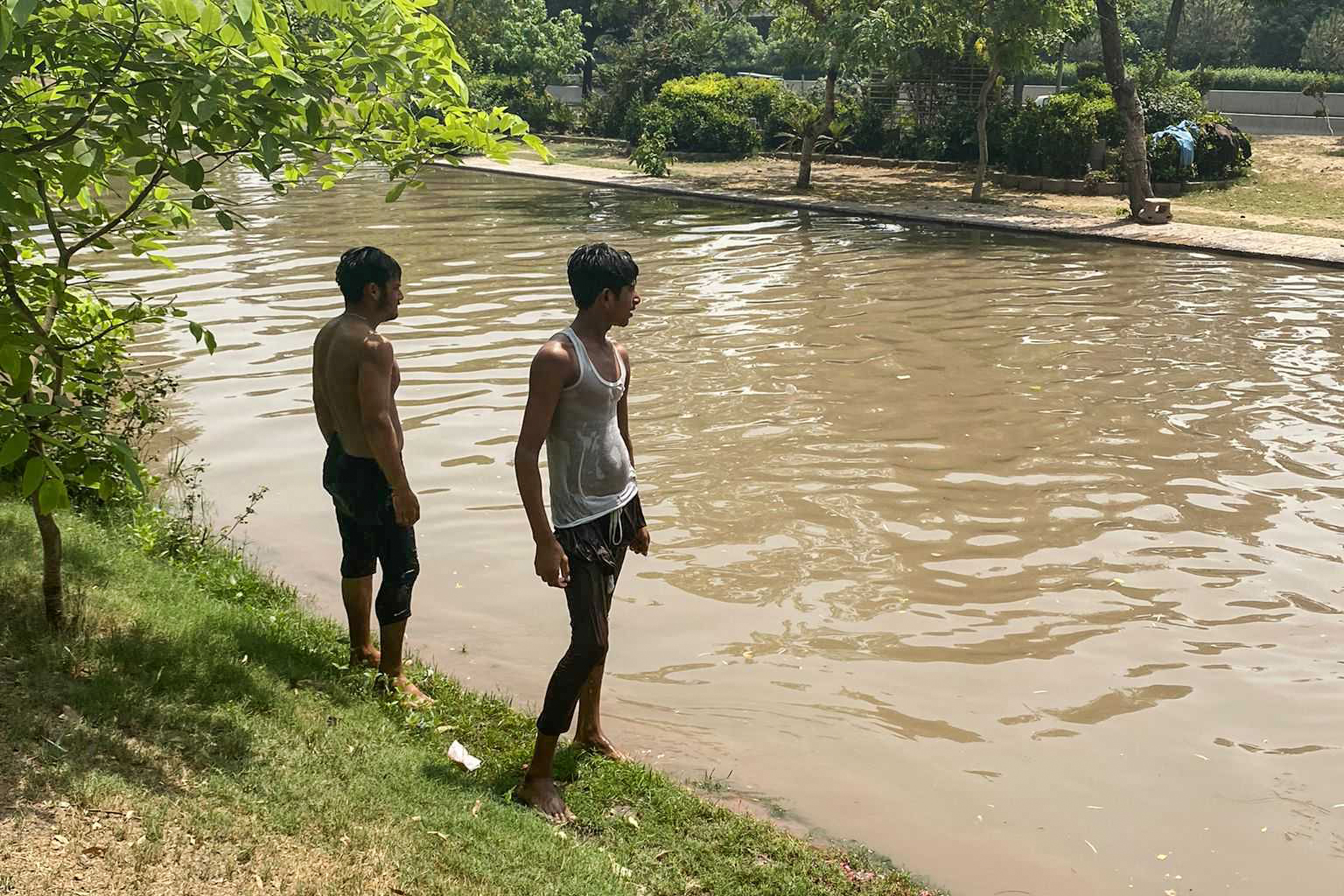 Two young men next to a water canal