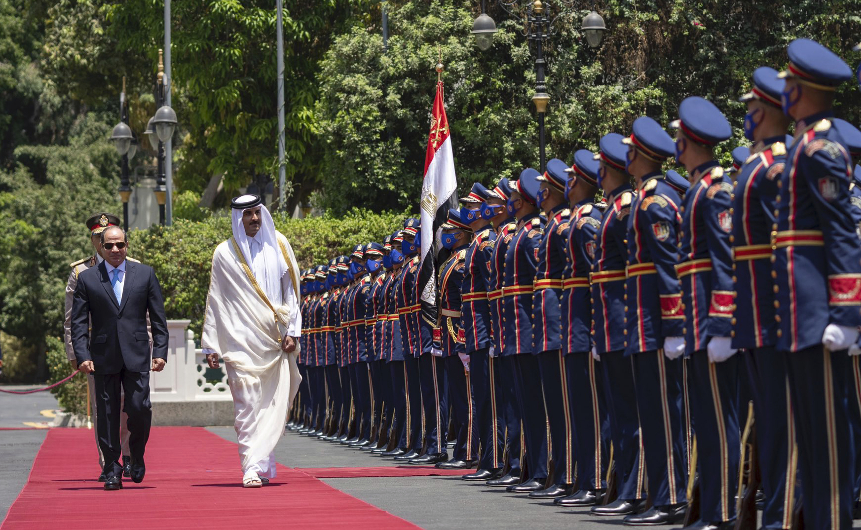 Qatari Emir Tamim bin Hamad Al Thani, and Egyptian President Abdel-Fattah el-Sissi, review an honour guard at the presidential palace in Cairo, Egypt on Saturday, June 25, 2022 [QNA via AP]