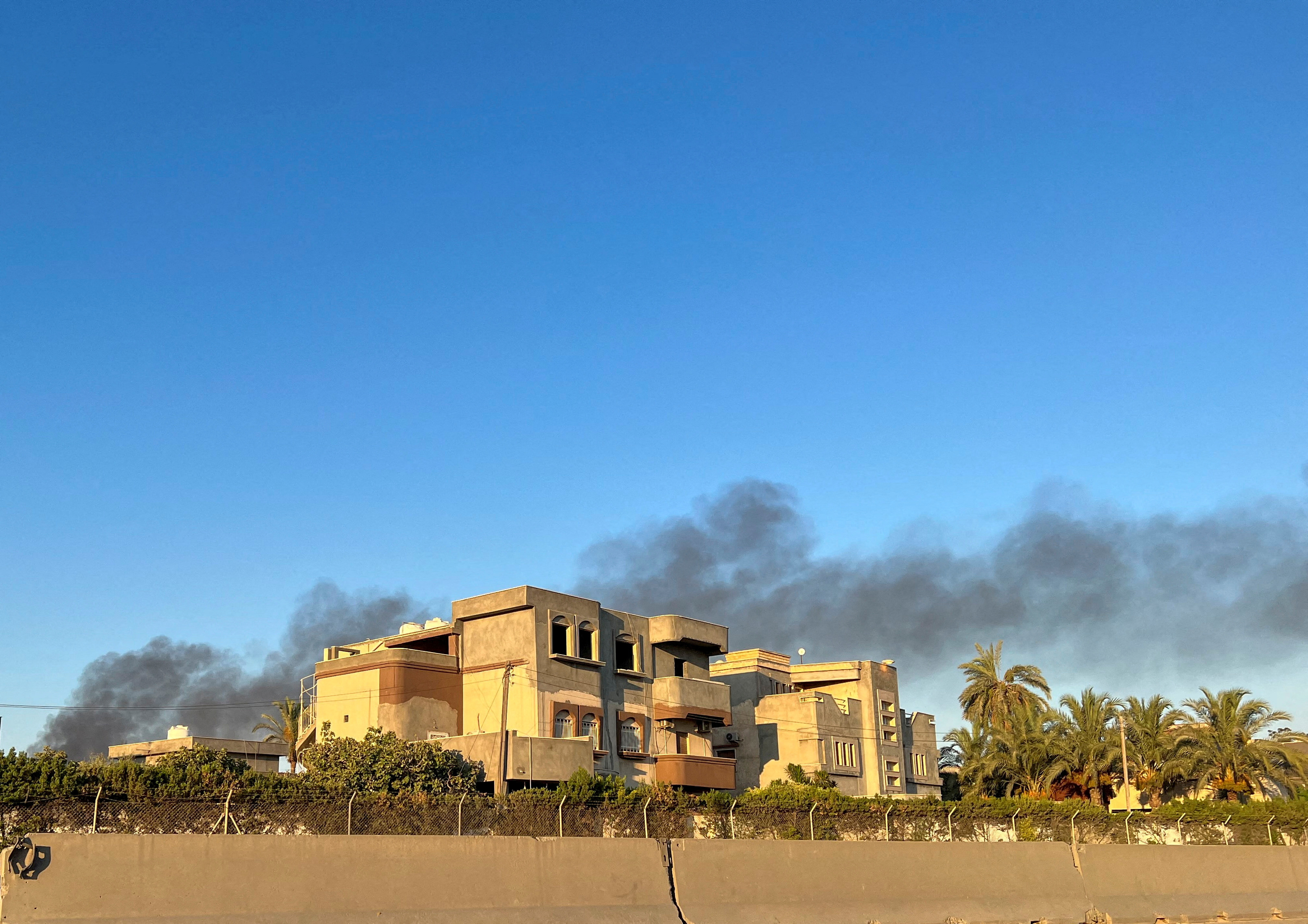 Smoke rises above buildings in Tripoli