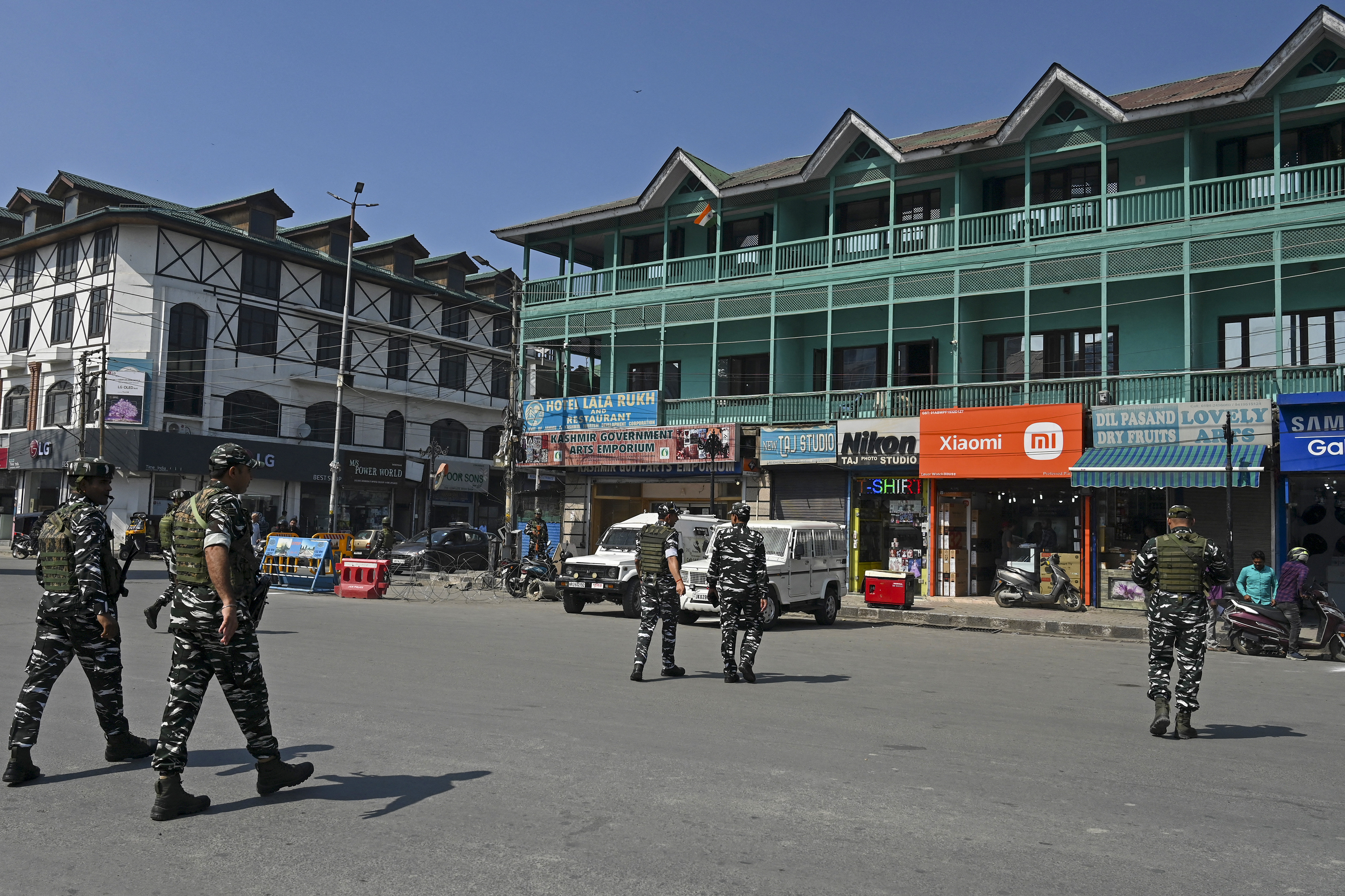 Indian paramilitary troopers patrol along a street in Srinagar