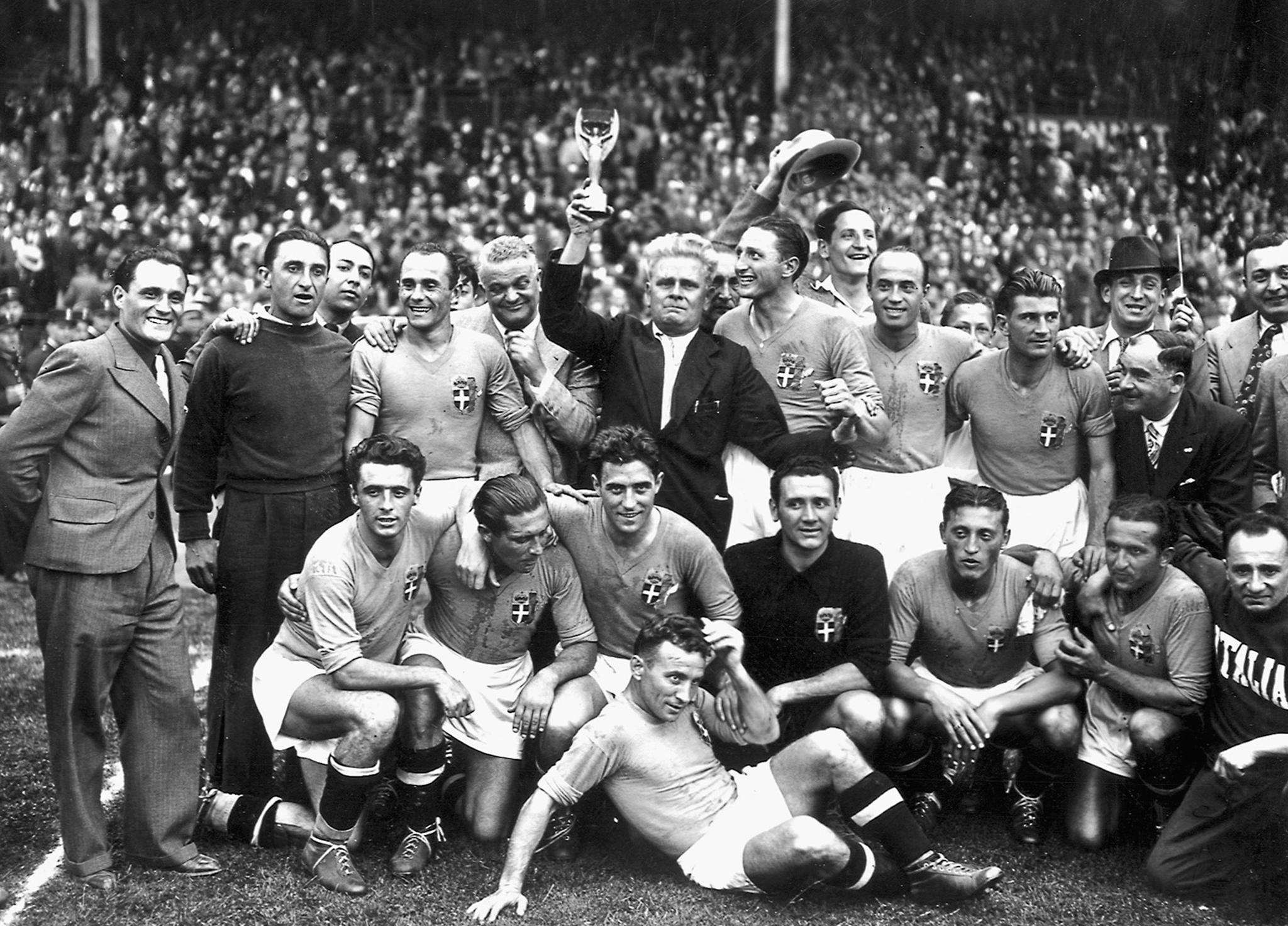 Italy's national soccer team poses with the World Cup trophy after beating Hungary 4-2 in the World Cup final