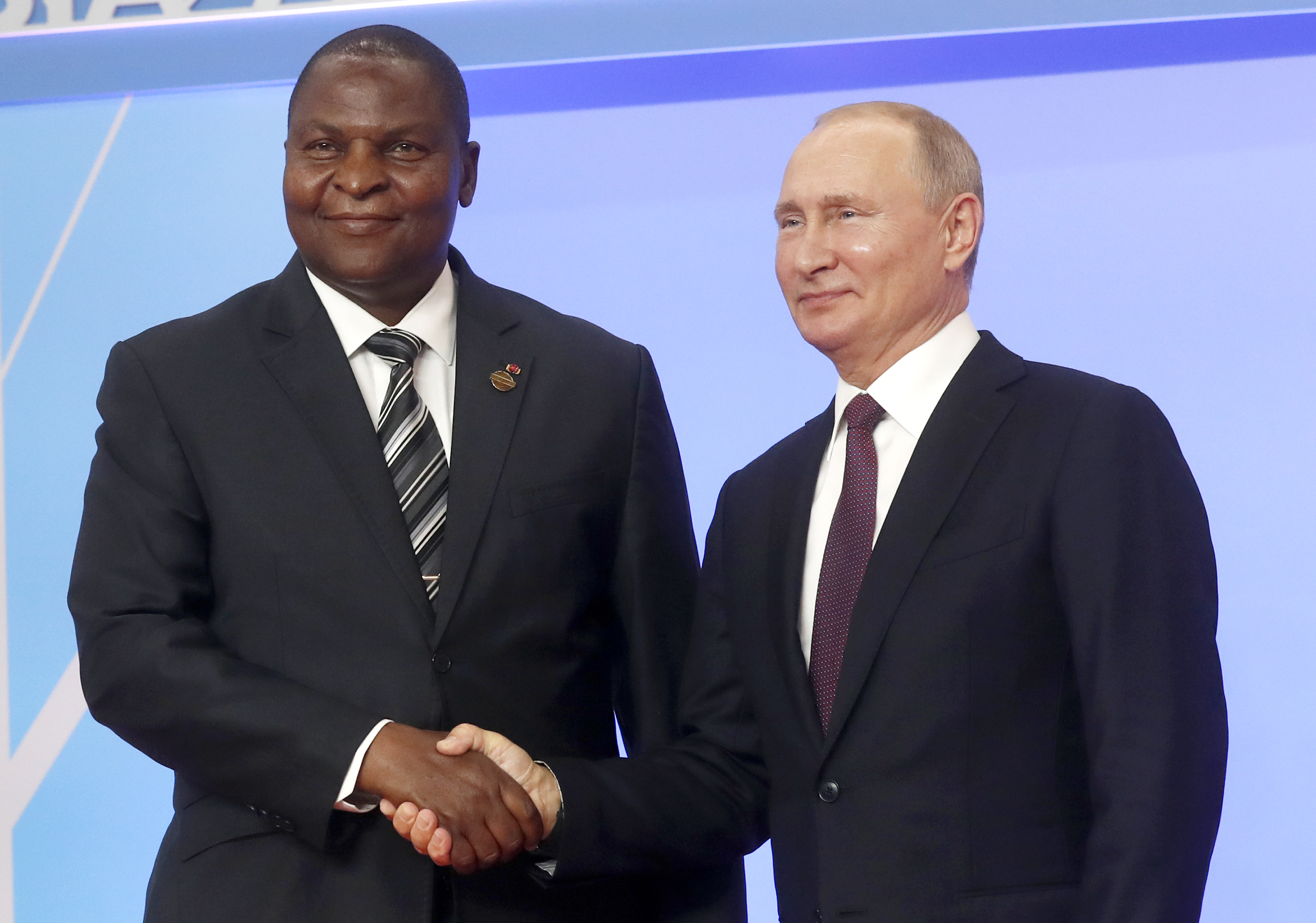 Russian President Vladimir Putin, right, and President of the Central African Republic Faustin Archange Touadera pose for a photo during a welcome ceremony of the Russia-Africa summit in the Black Sea resort of Sochi, Russia, Wednesday, Oct. 23, 2019. (AP Photo/Sergei Chirikov, pool photo via AP)