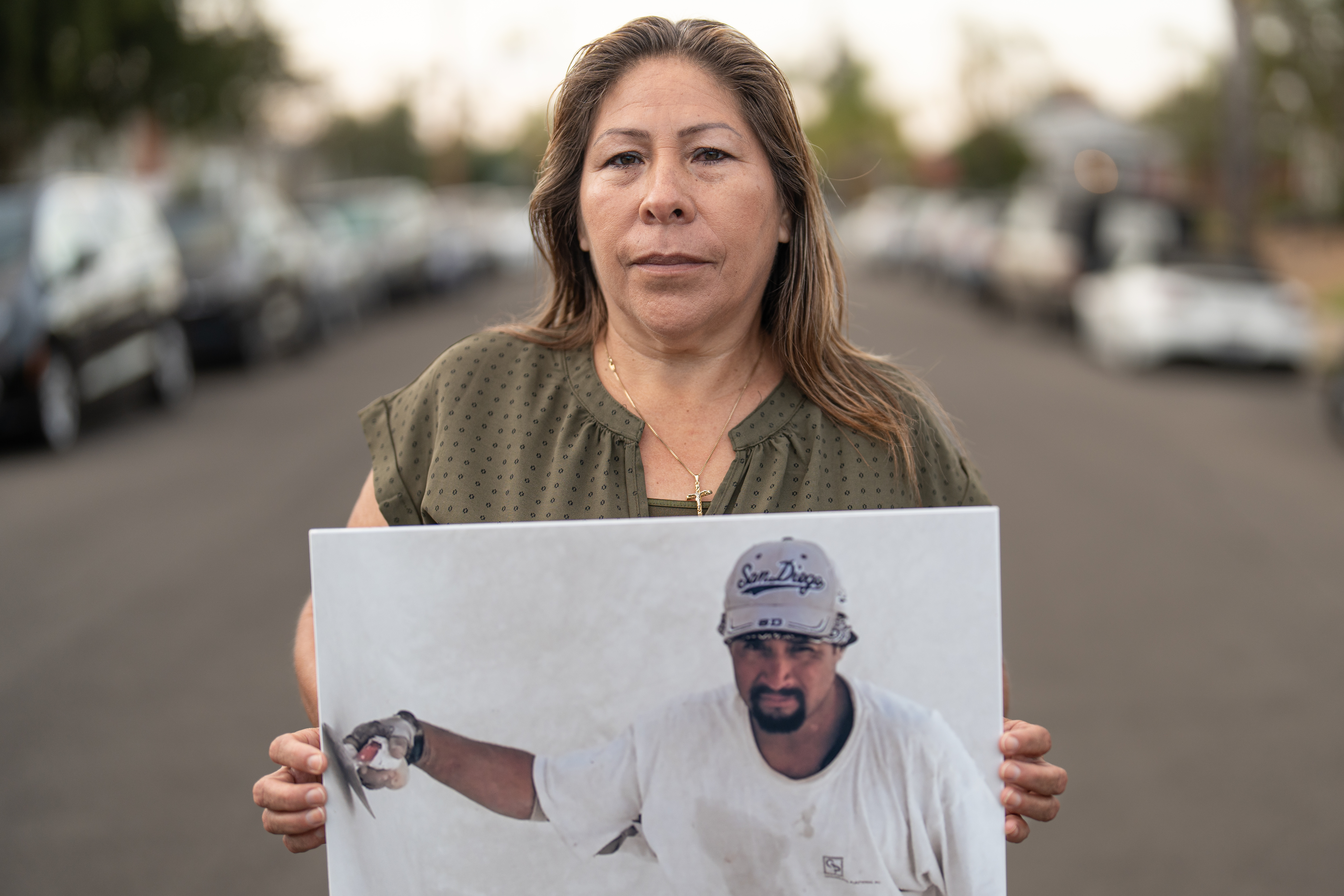 A photo of a person holding a photo of a person in front of them.