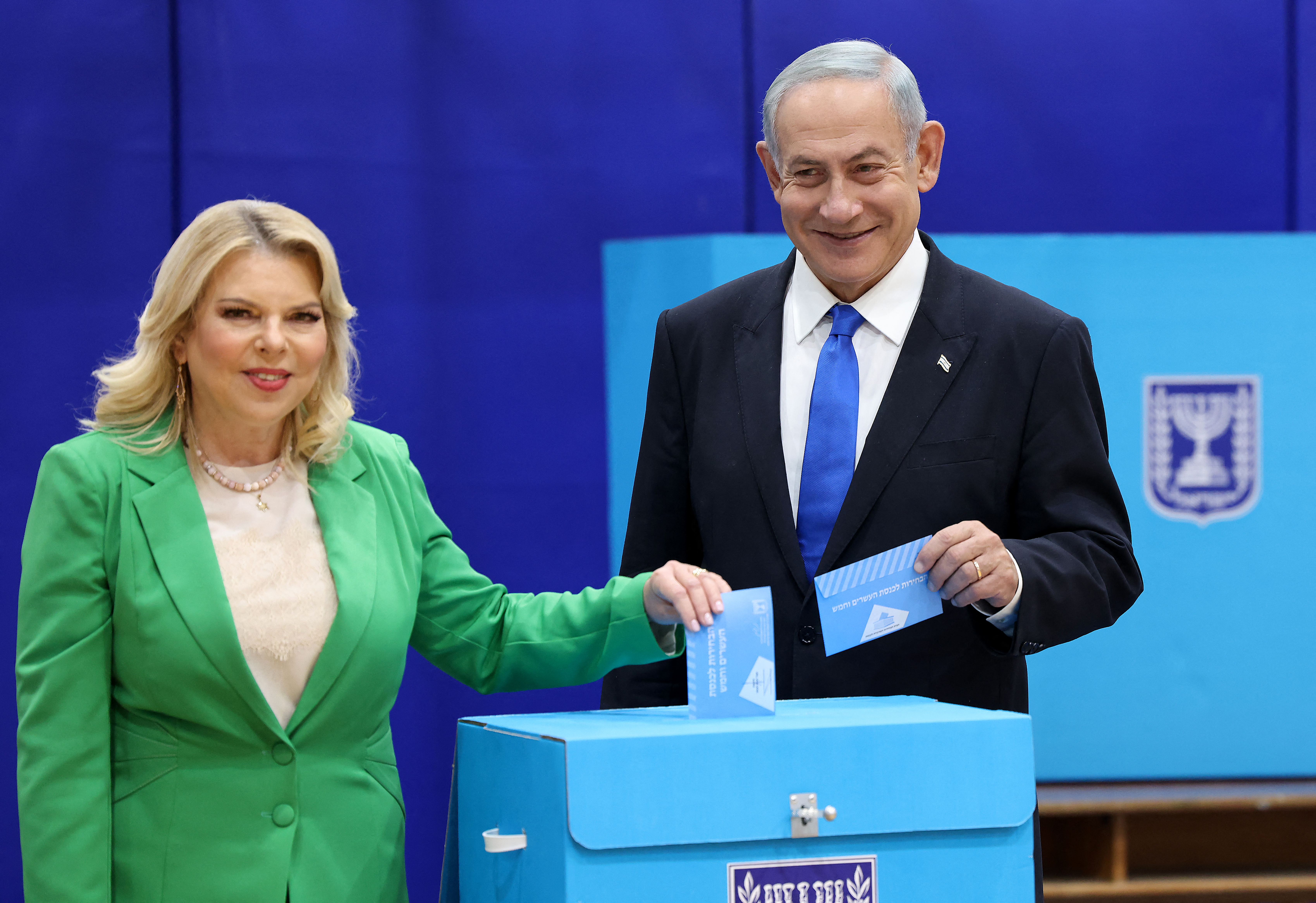 Likud chairman Benjamin Netanyahu (R) and his wife Sara