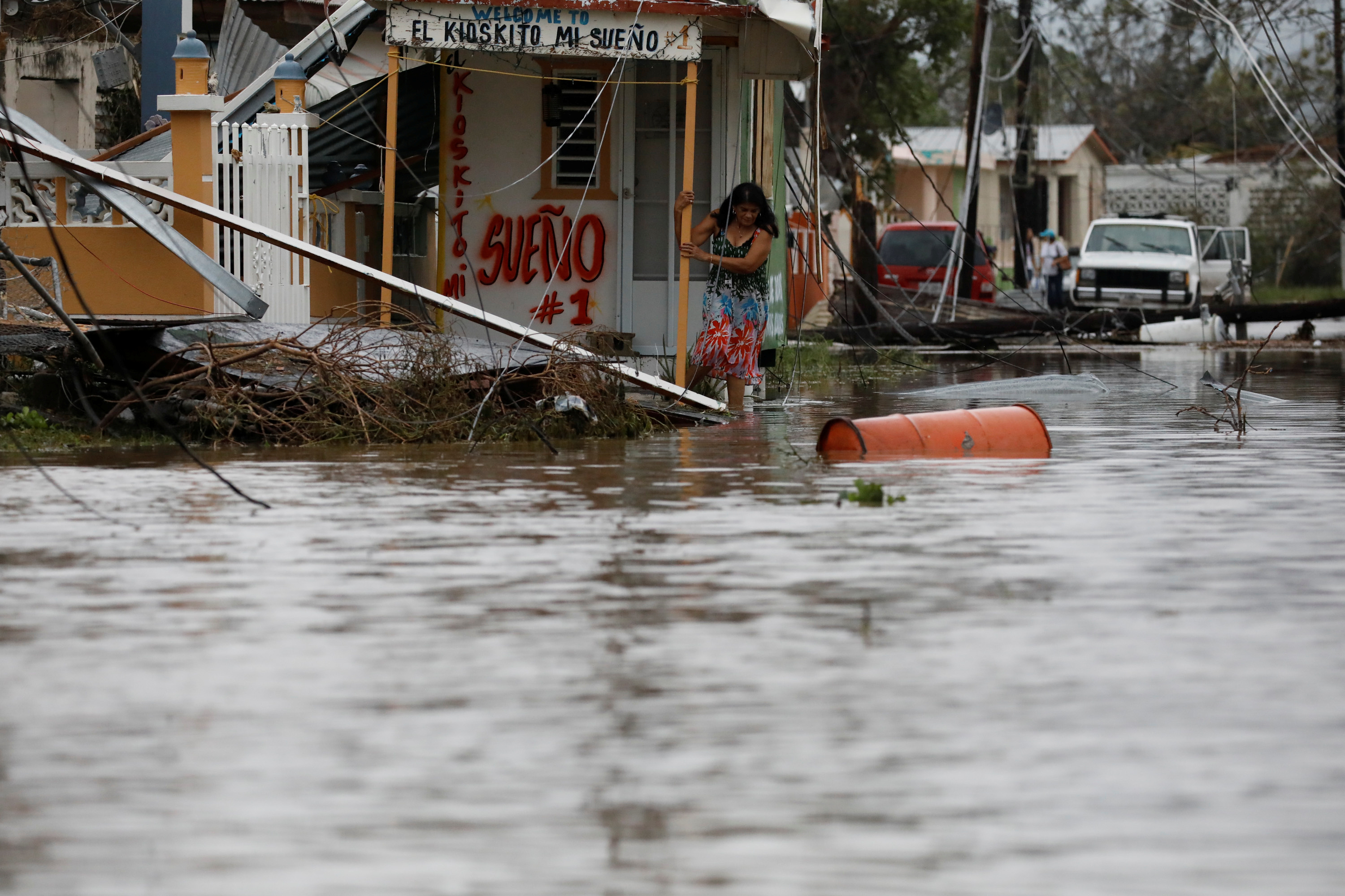 A woman tries to naviage flood waters in Puerto Rico after a hurricane