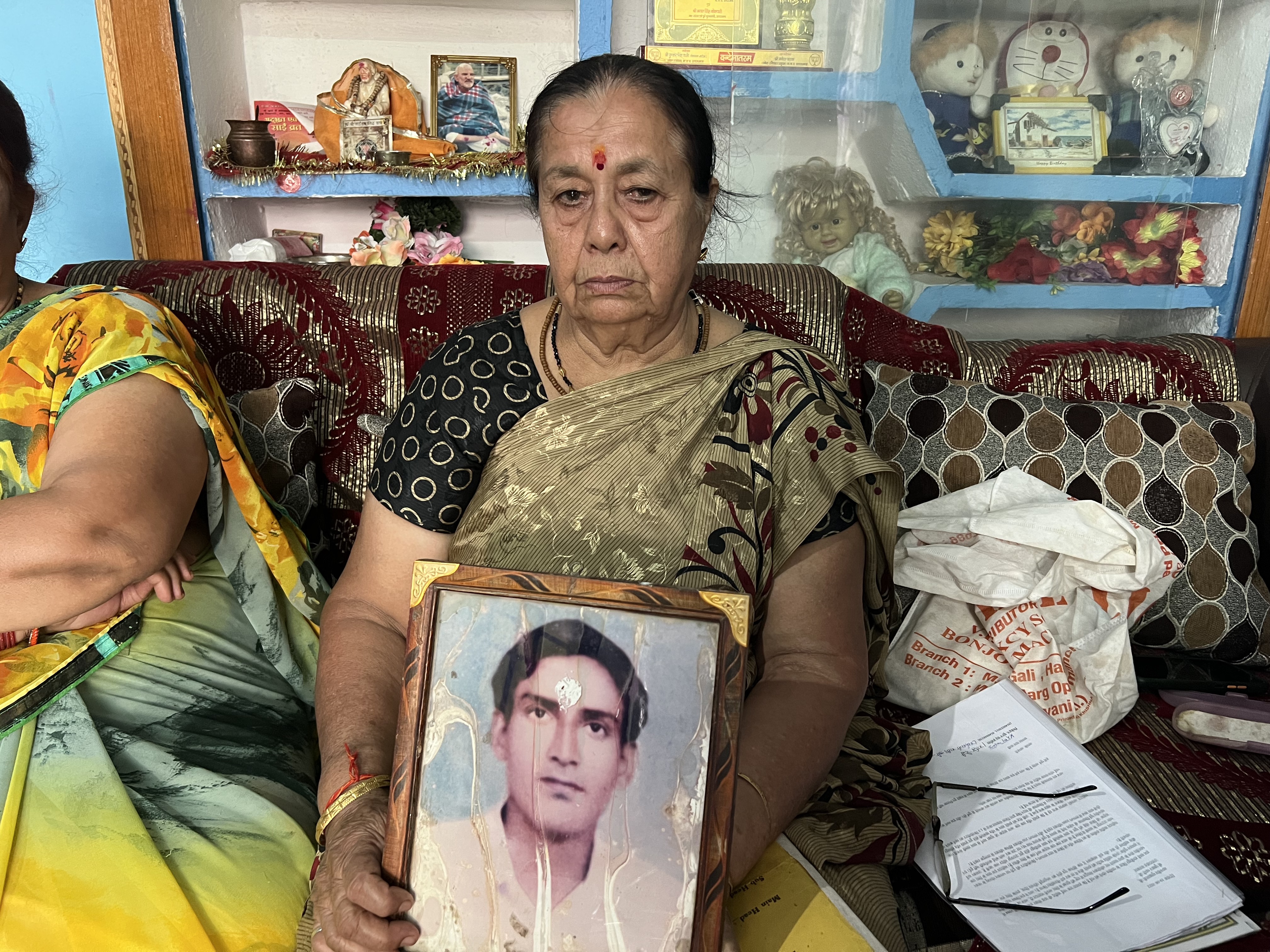 Shanti Devi holds a picture of her husband