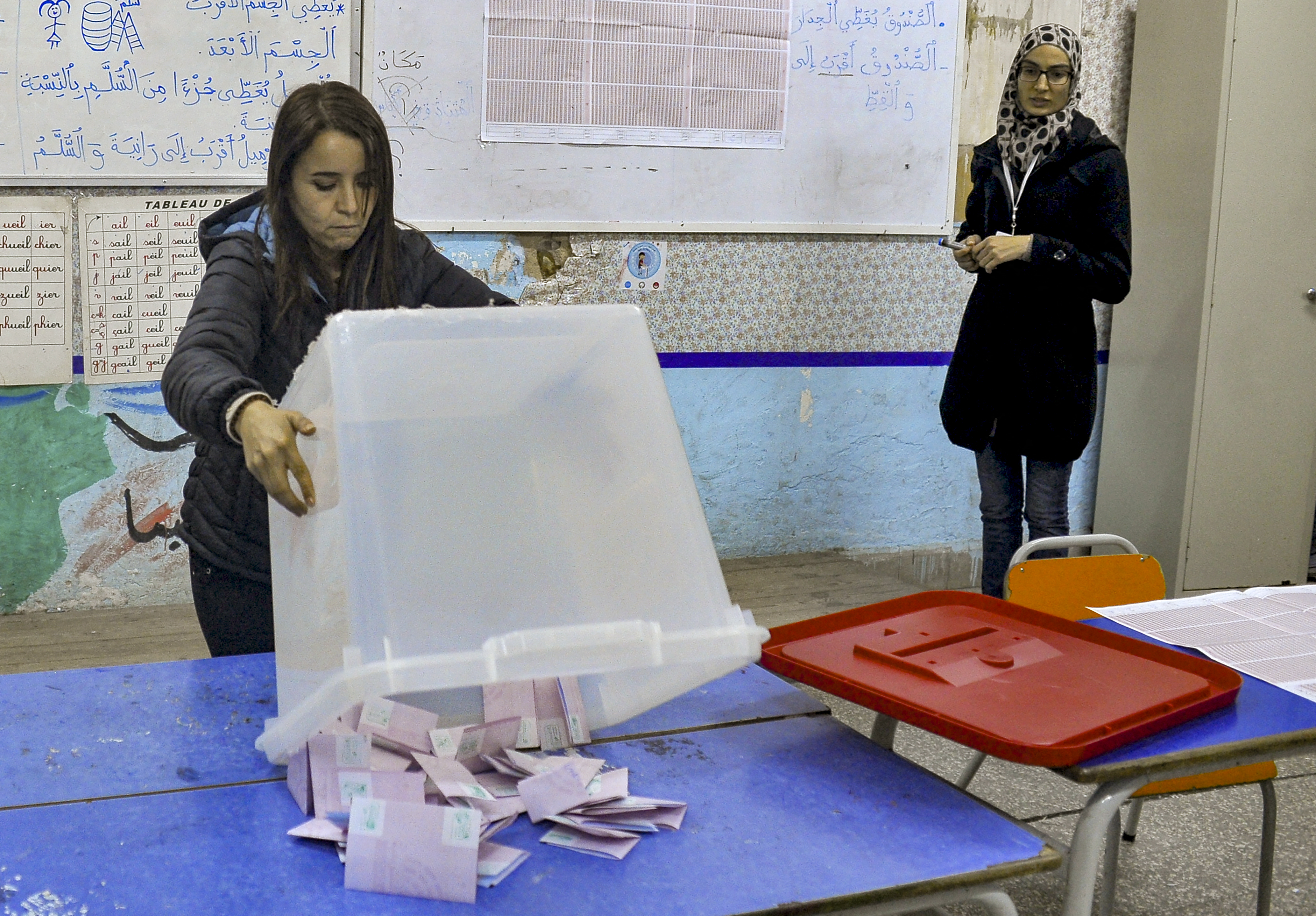 An ISIE agent begins counting ballots at a polling station in Tunis