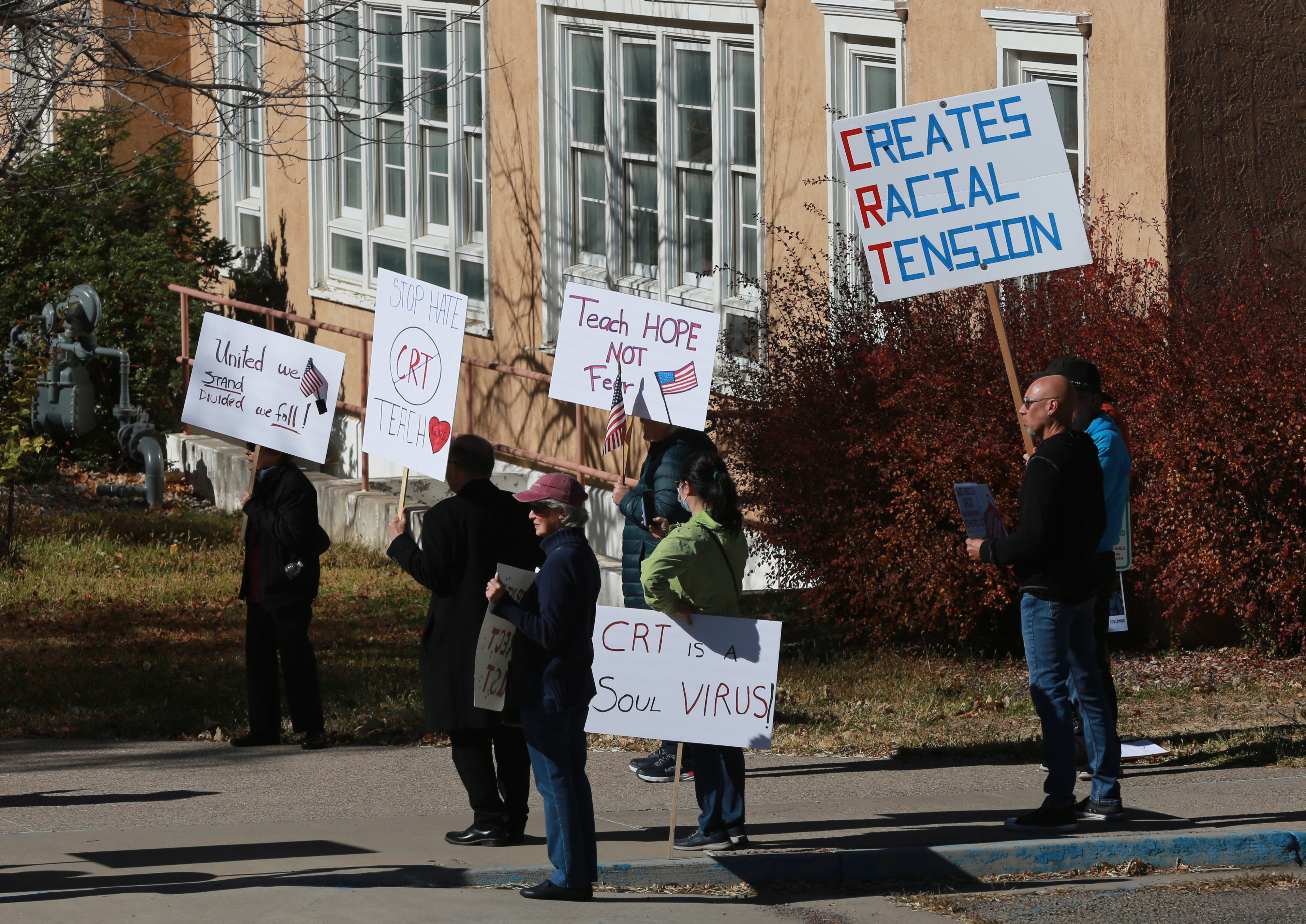 People protest outside the offices of the New Mexico Public Education Department's office to restrict discussion of race, gender, and identity in the classroom, in Albuquerque, New Mexico.
