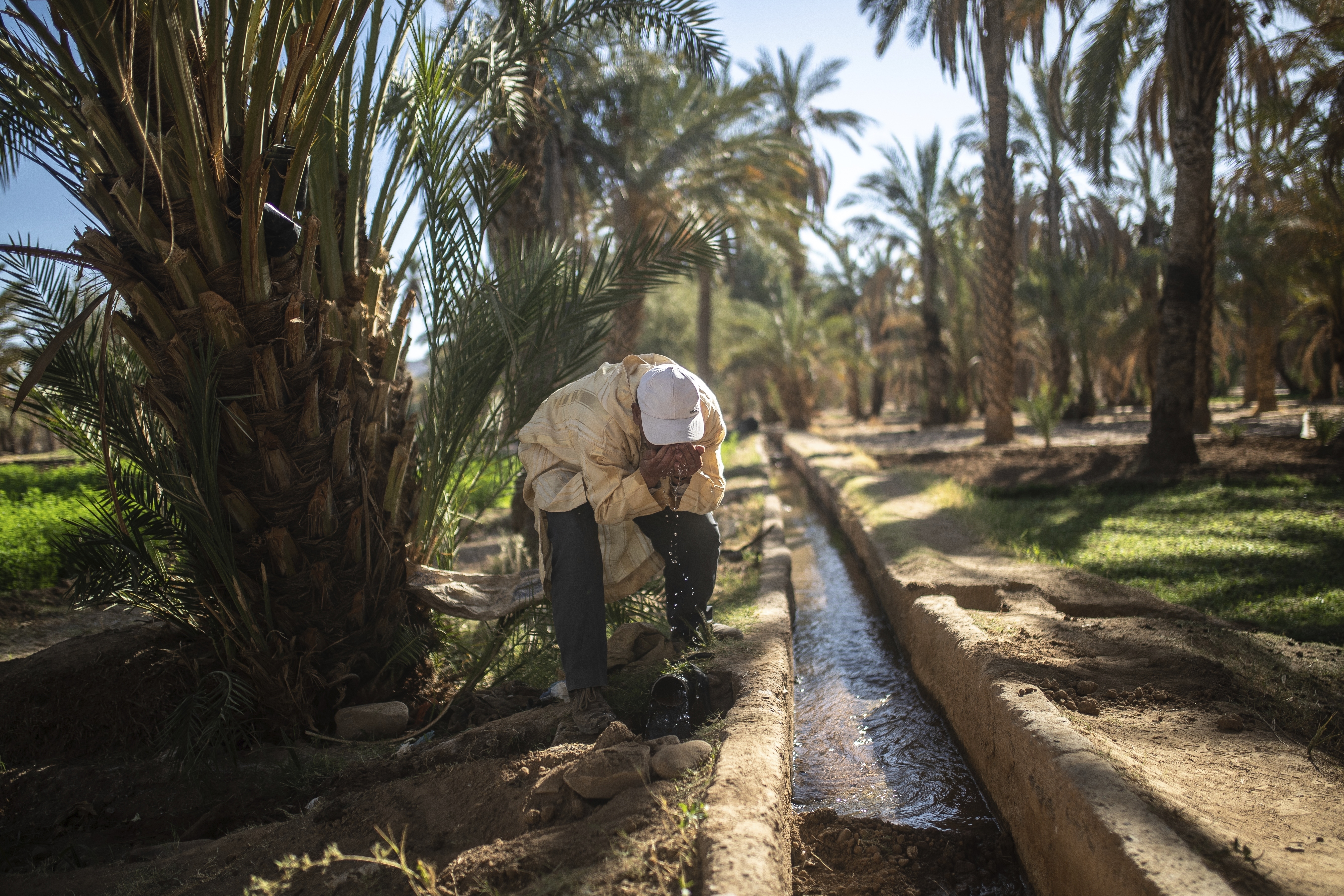 A farmer drinks water