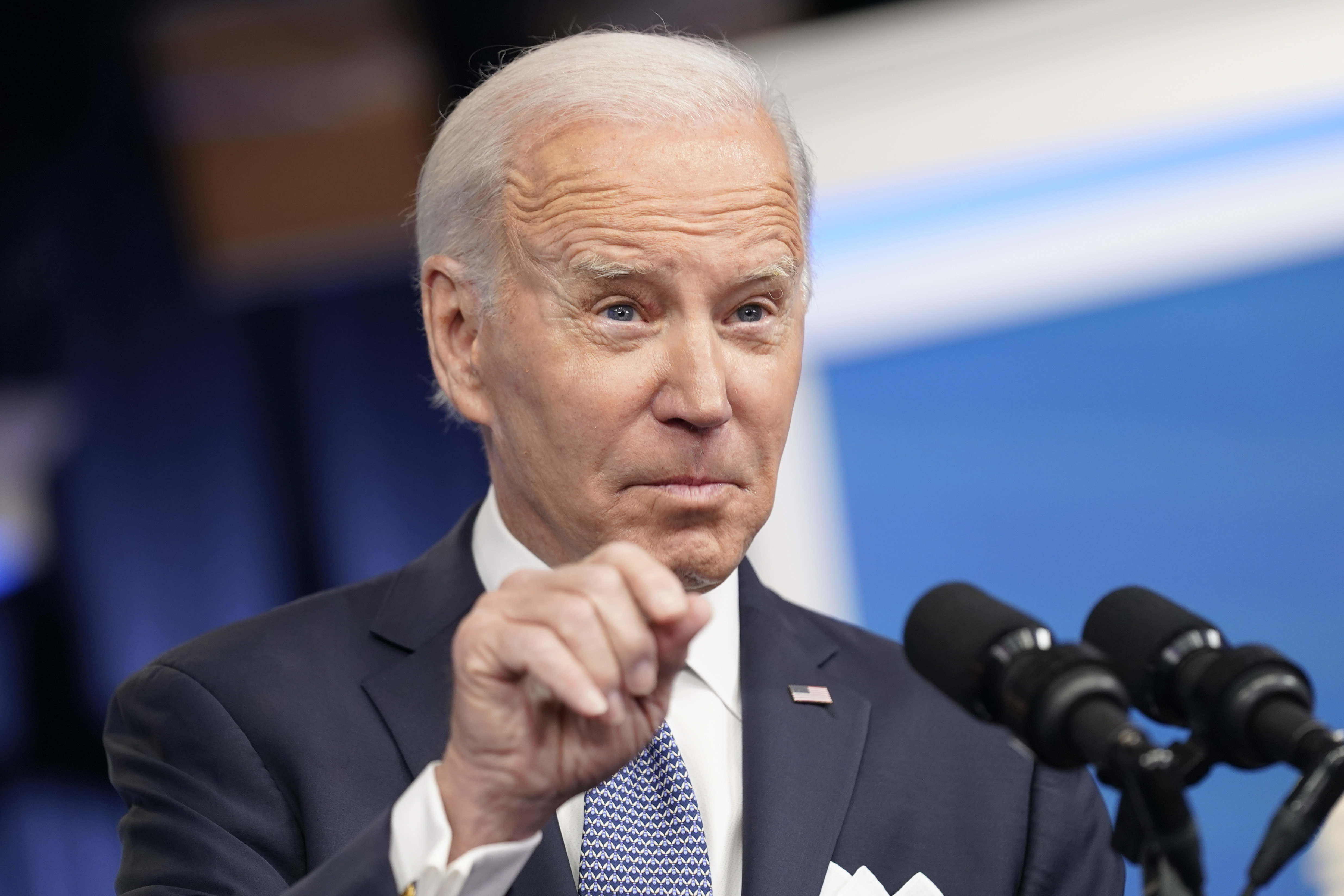 Joe Biden points a finger in a press conference.