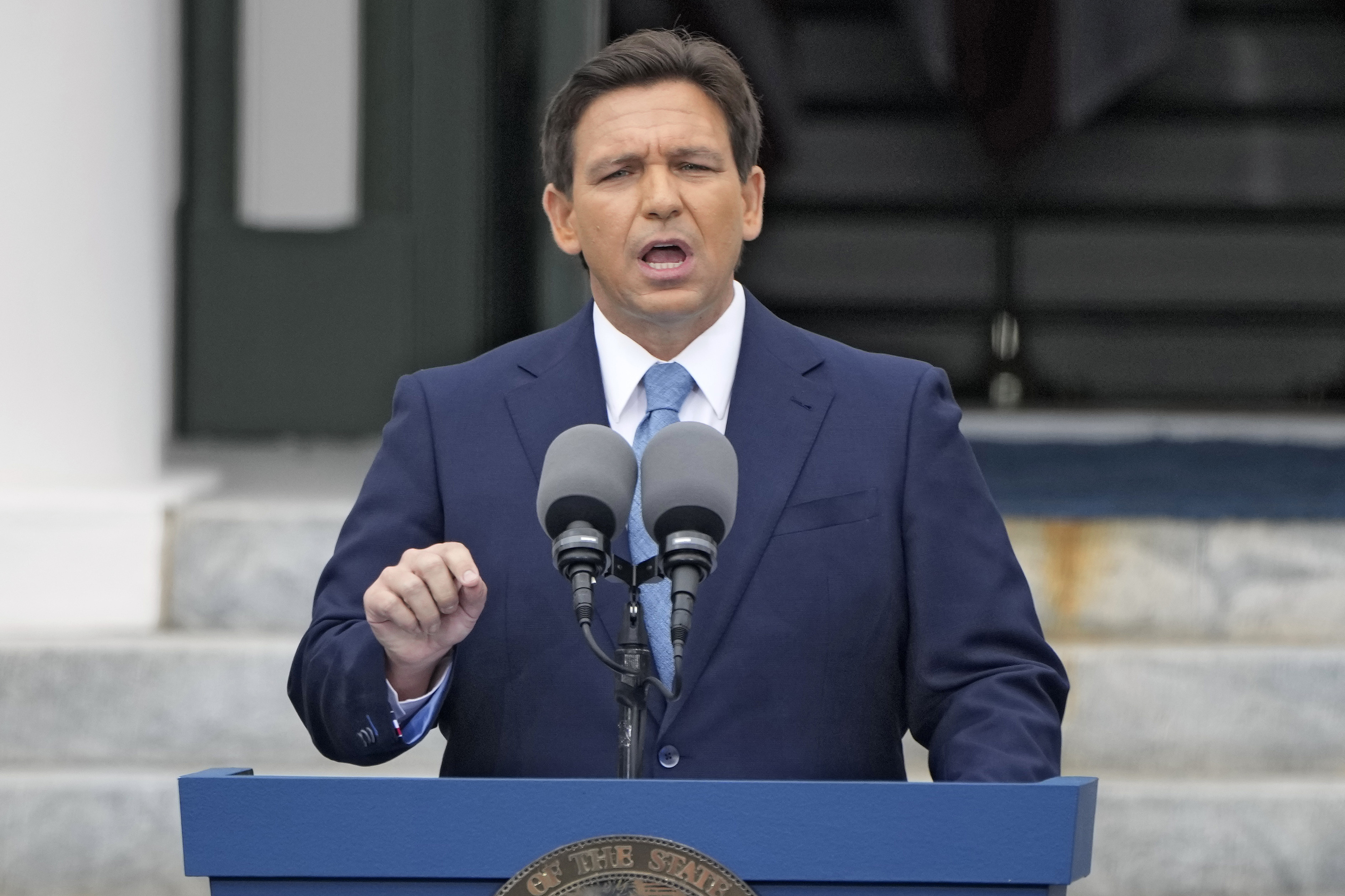 Florida governor Ron DeSantis speaks at an outdoor podium