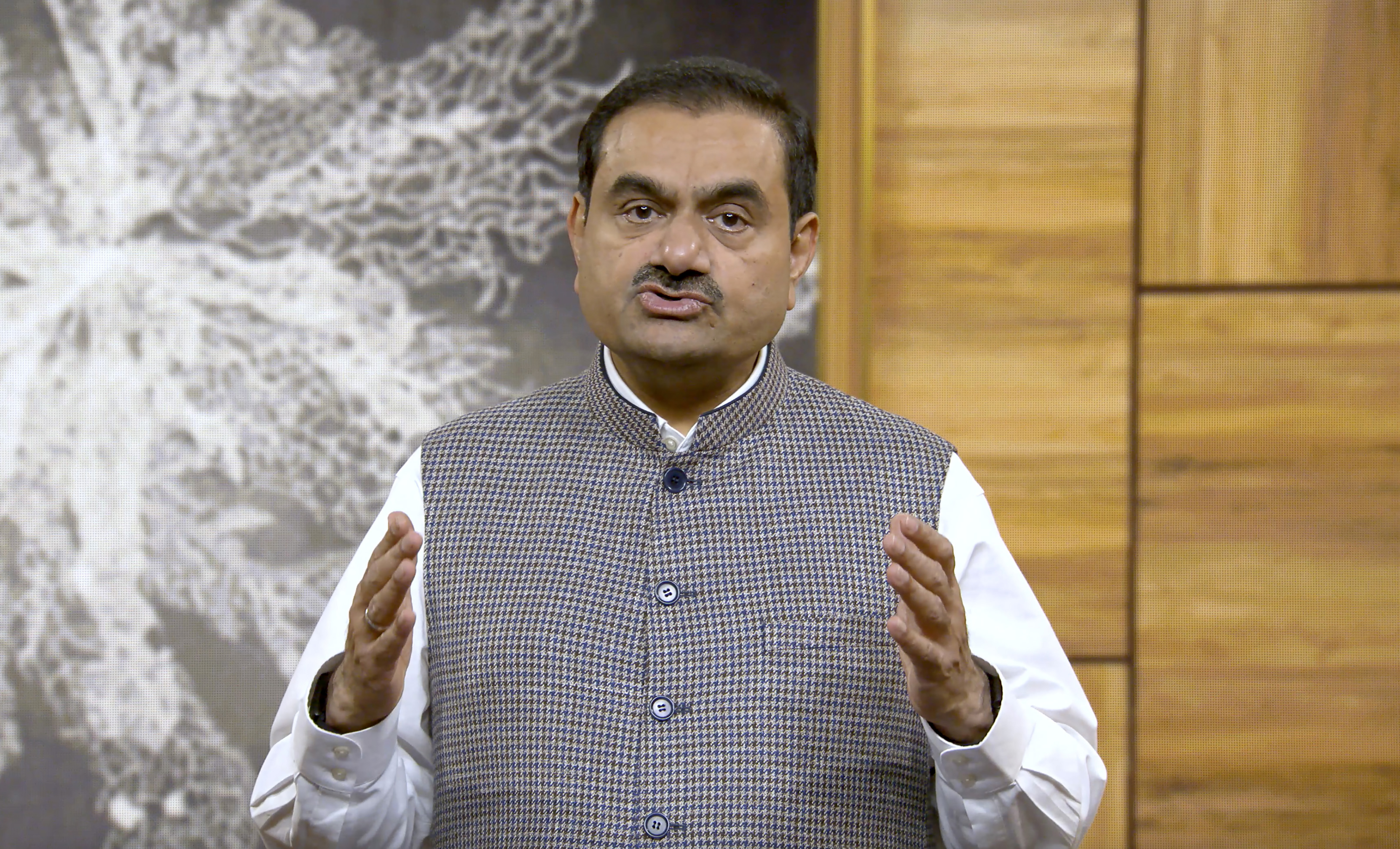 Indian billionaire Gautam Adani addressing investors from an unknown location