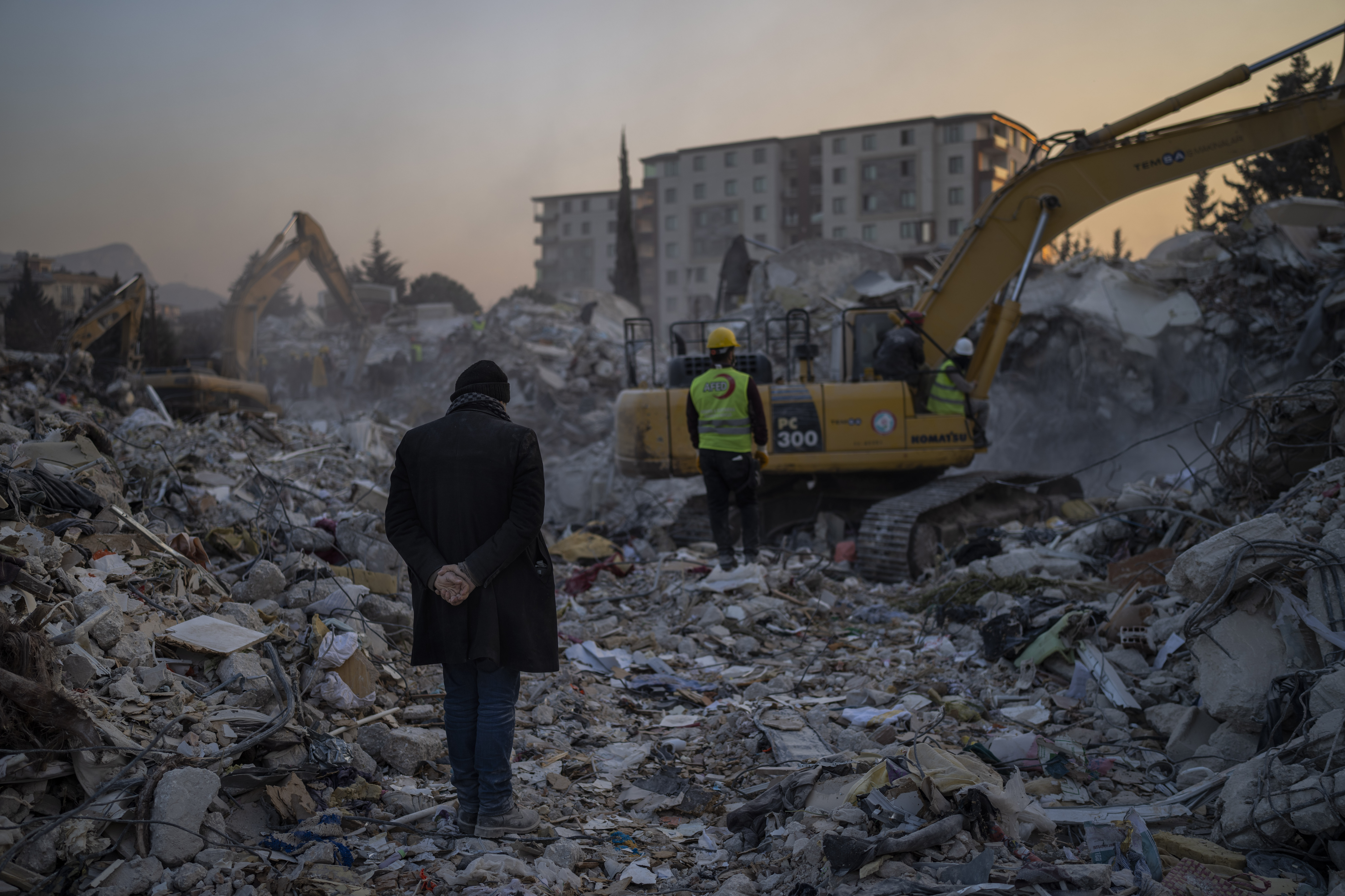 A man stands on top of the rubble of his house destroyed during an earthquake in Antakya, southeastern Turkey.