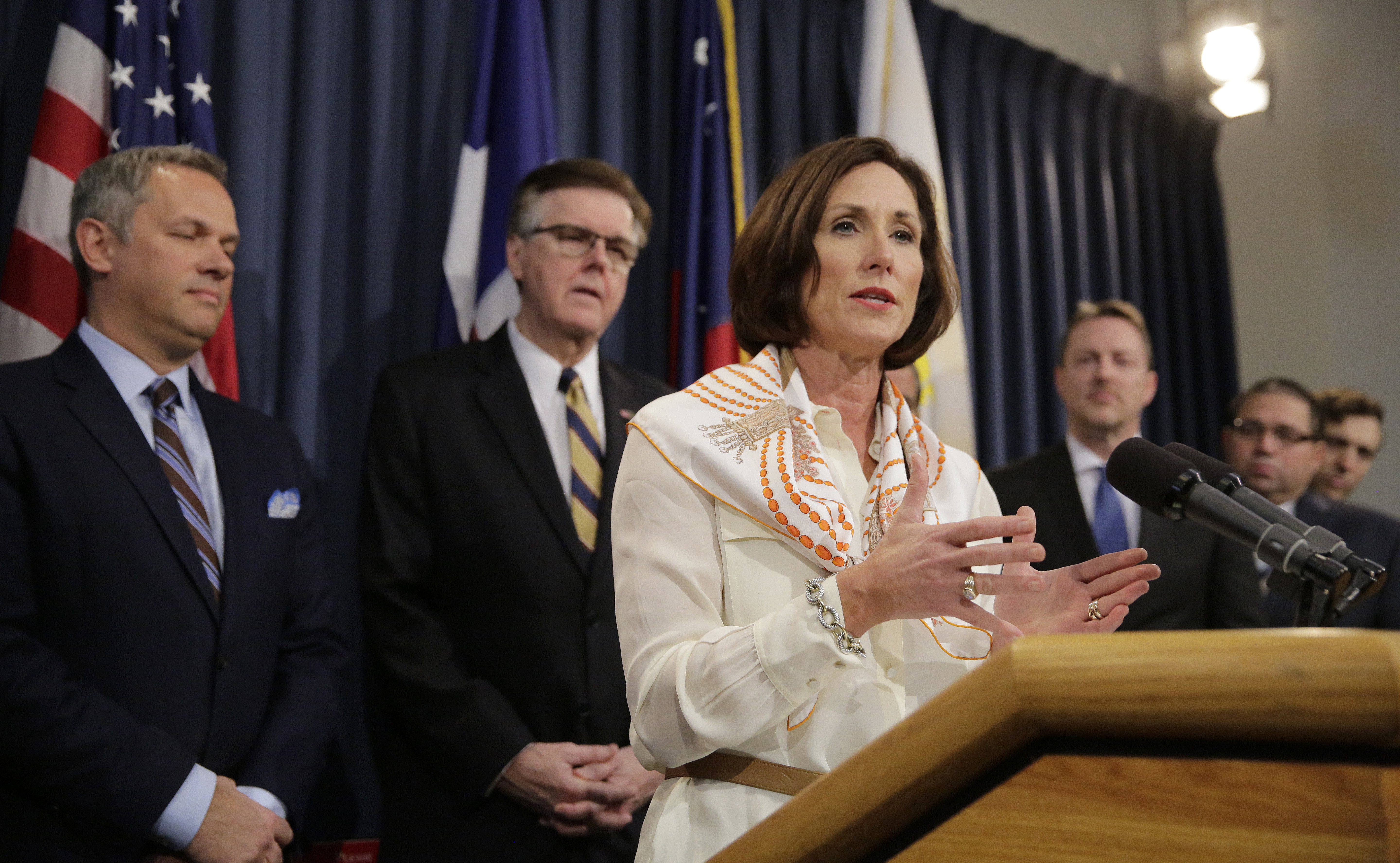 FILE - In this March 6, 2017, file photo, Texas Sen. Lois Kolkhorst, front, backed by Texas Lt. Gov. Dan Patrick, center, and other legislators talks to the media during a news conference to discuss Senate Bill 6 at the Texas Capitol in Austin, Texas. Just months after a high-profile study revealed that Texas has one of the highest maternal mortality rates in the developed world, state lawmakers failed to respond by passing comprehensive legislation to combat the crisis during the legislative session. (AP Photo/Eric Gay, File)