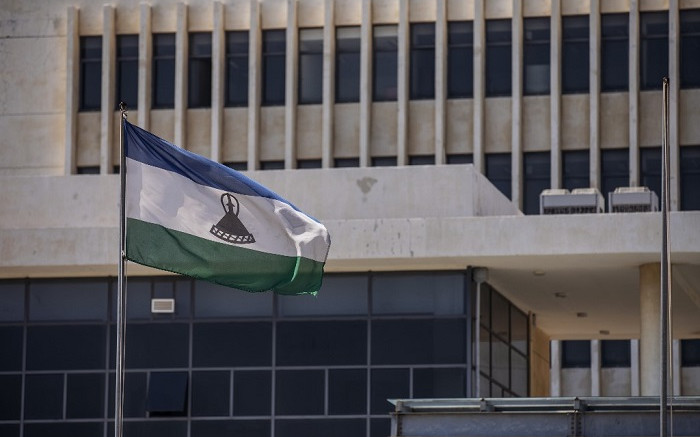 picture taken in Maseru, on January 31, 2020 shows the flag of Lesotho outside the Parliament building. [Michele Spatari / AFP]