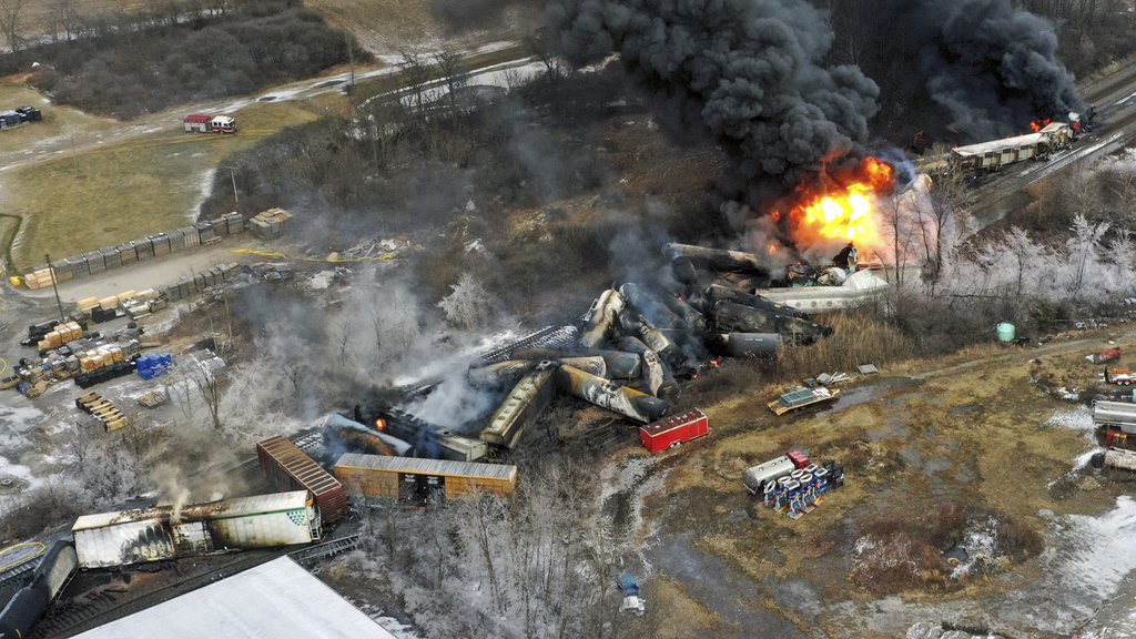 A photo shows the a fire blazing in the aftermath of a train derailment in East Palestine, Ohio in February