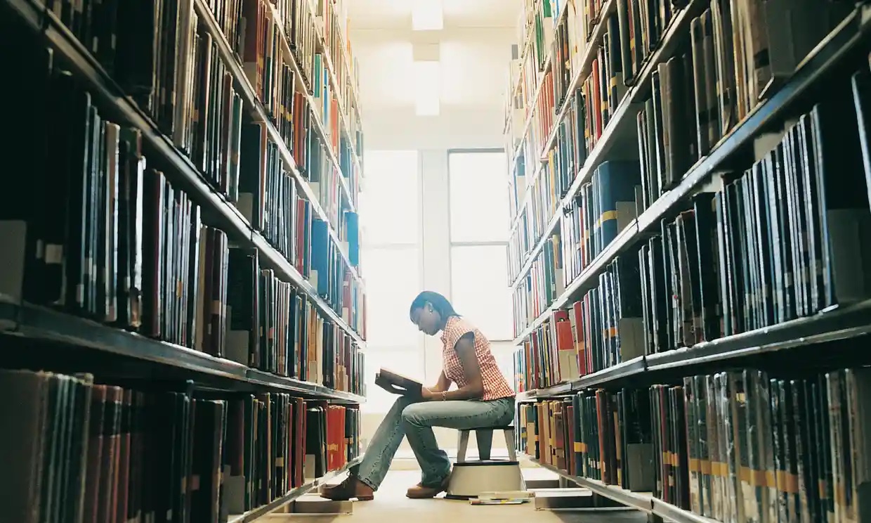 University student reading in a library