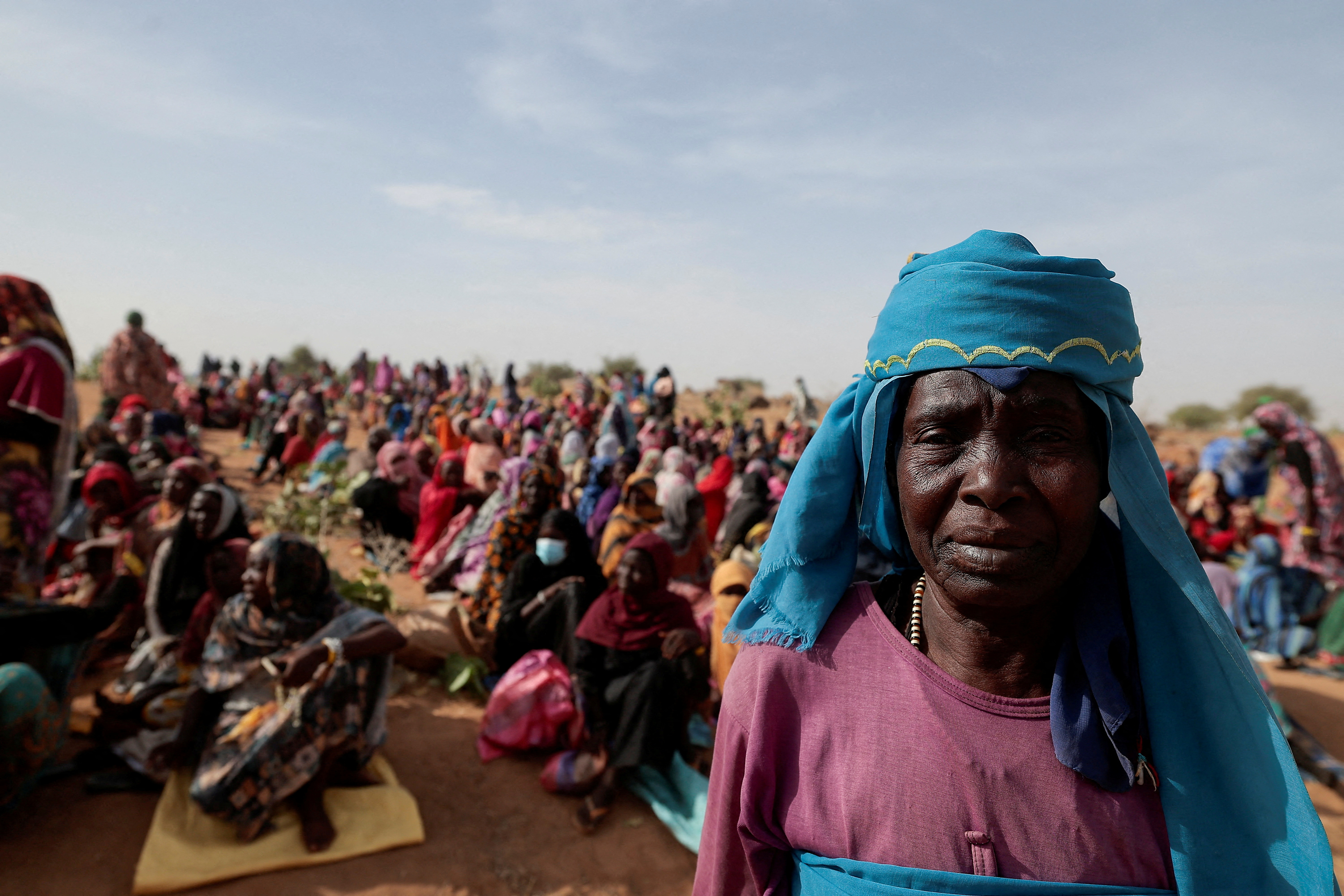 Sudanese refugees in Chad wait to receive food aid
