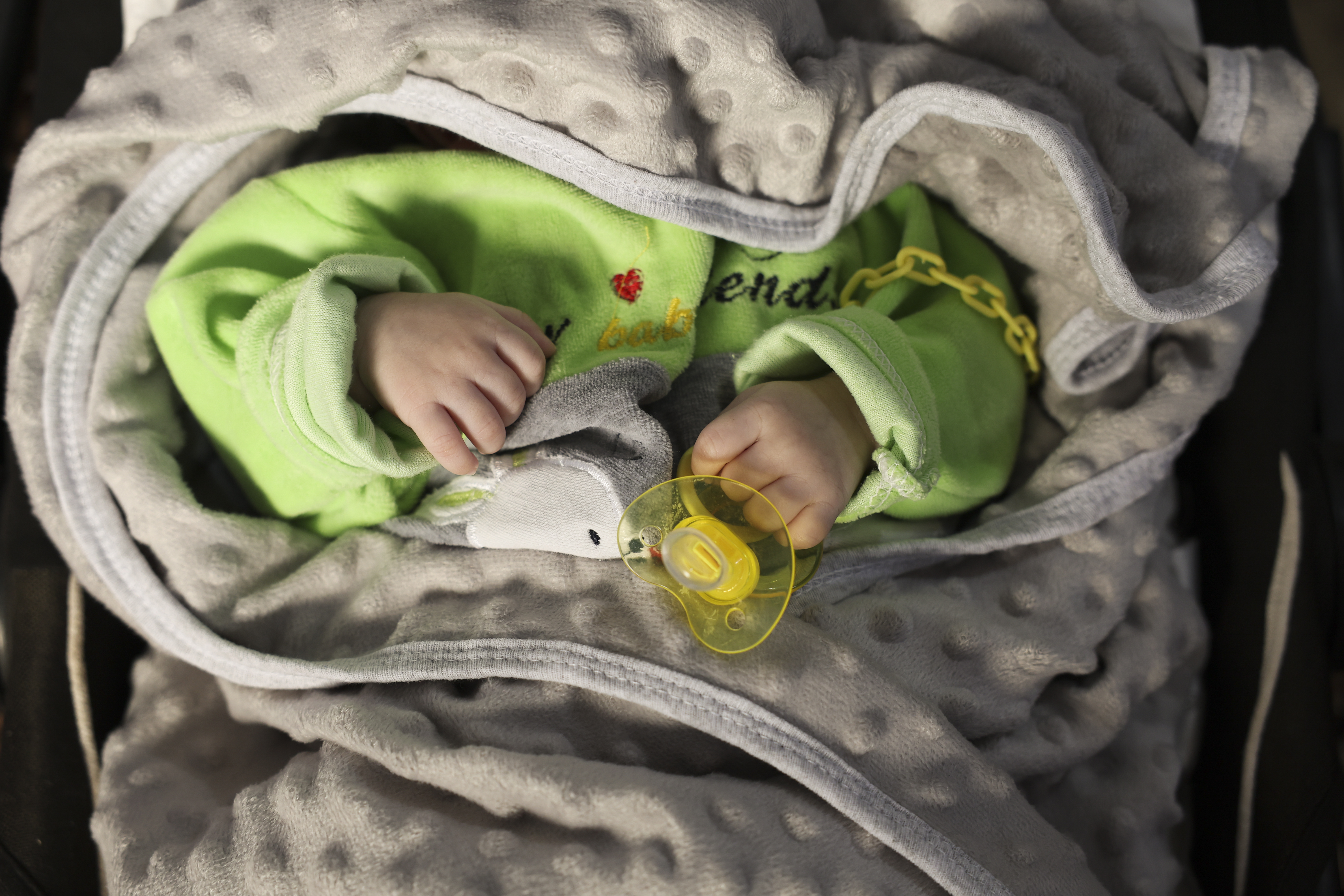 a baby in a crib at the 'Child Houses' center in rebel-held Idlib