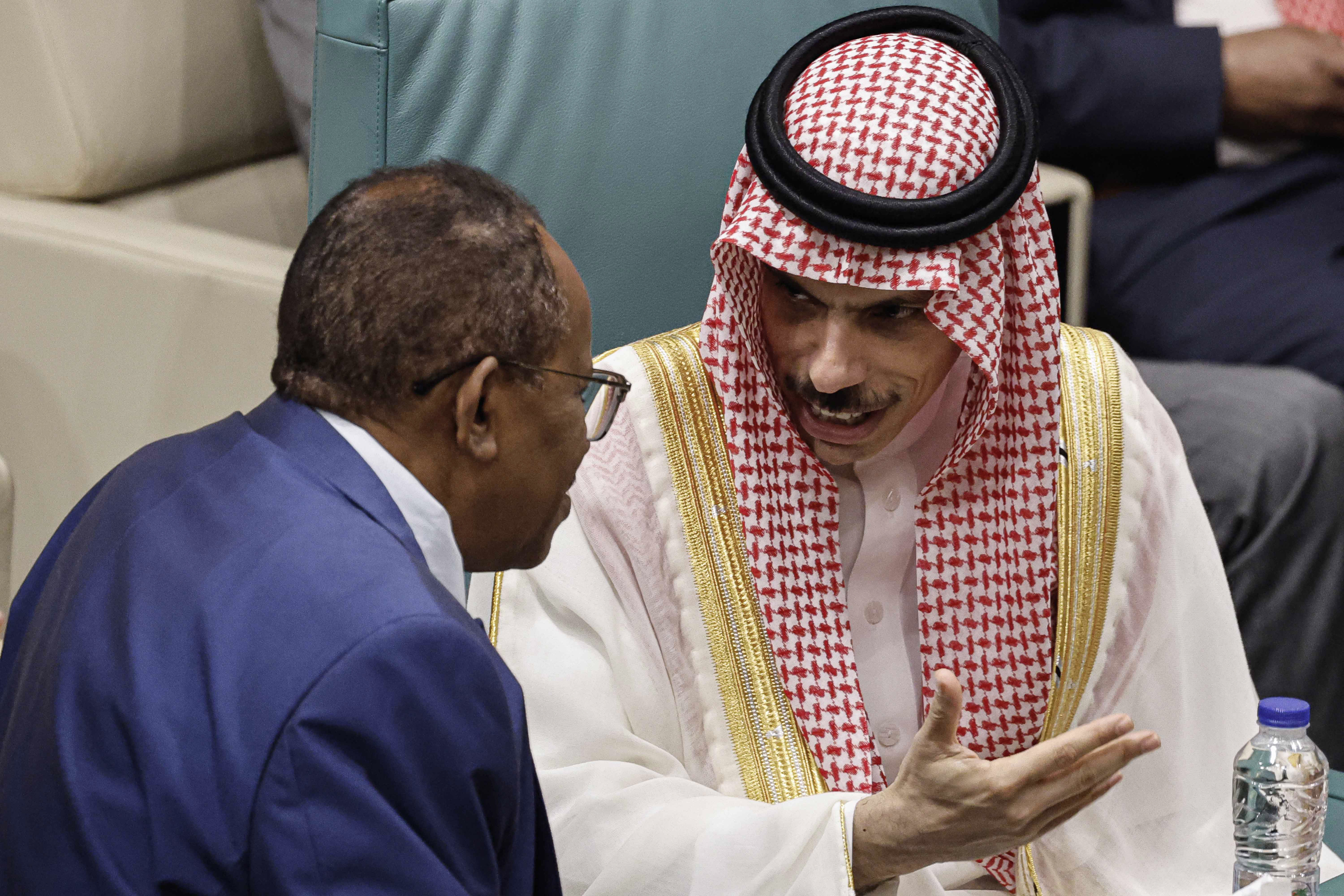 Saudi Arabia's Foreign Minister Faisal bin Farhan (right) speaks with Sudan's Ambassador to Egypt Abdelaziz Hassan Saleh during an emergency meeting of Arab League foreign ministers in Cairo, Egypt.