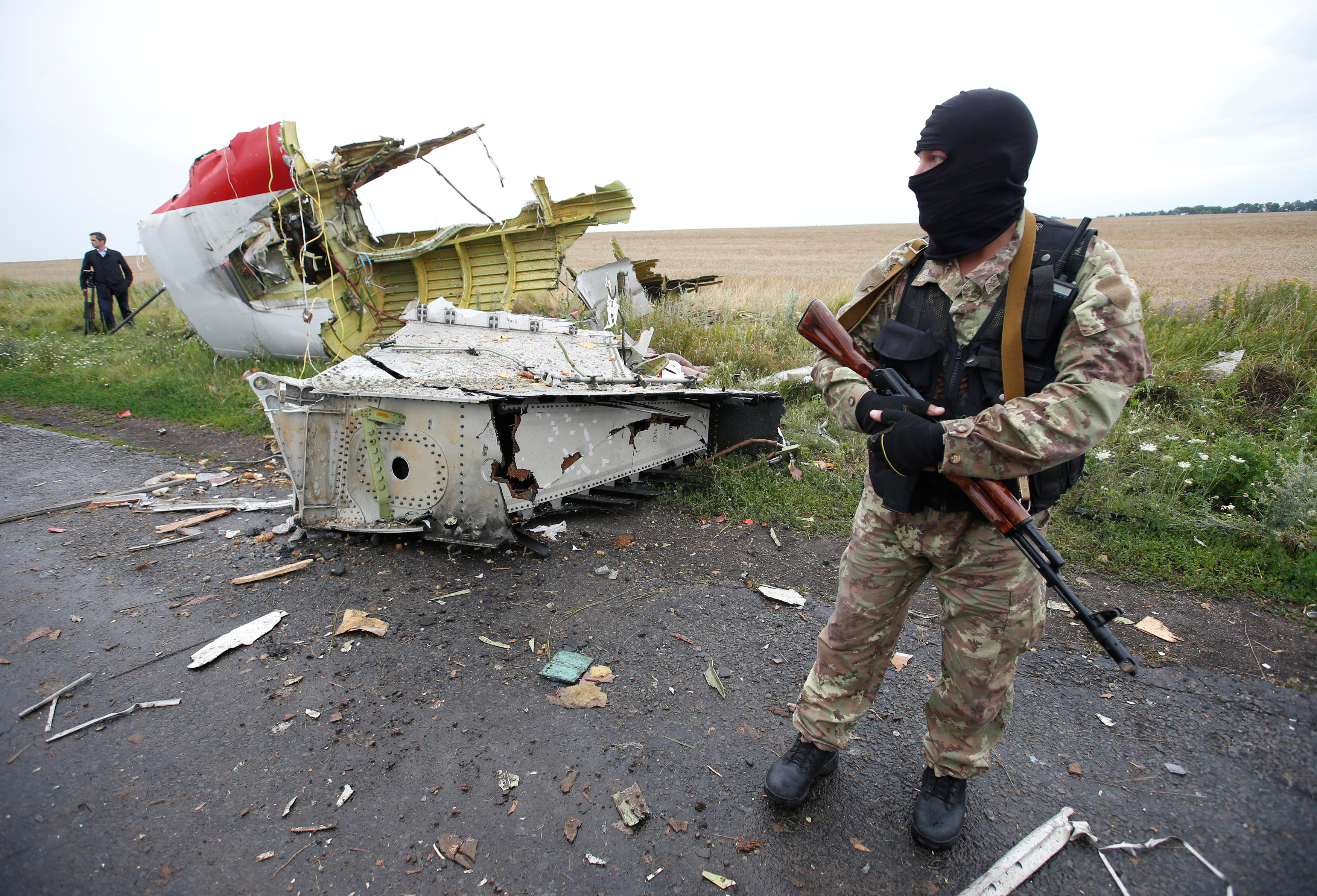 A pro-Russian separatist stands at the crash site of Malaysia Airlines flight MH17, near the settlement of Grabovo in the Donetsk region, July 18, 2014. The Dutch are due to announce on Wednesday 28 September the long-awaited results of an investigation with Australia, Malaysia, Belgium and Ukraine into the July 17, 2014 downing of the flight. REUTERS/Maxim Zmeyev/File Photo FROM THE FILES PACKAGE - SEARCH "FILES MH17" FOR ALL 20 IMAGES