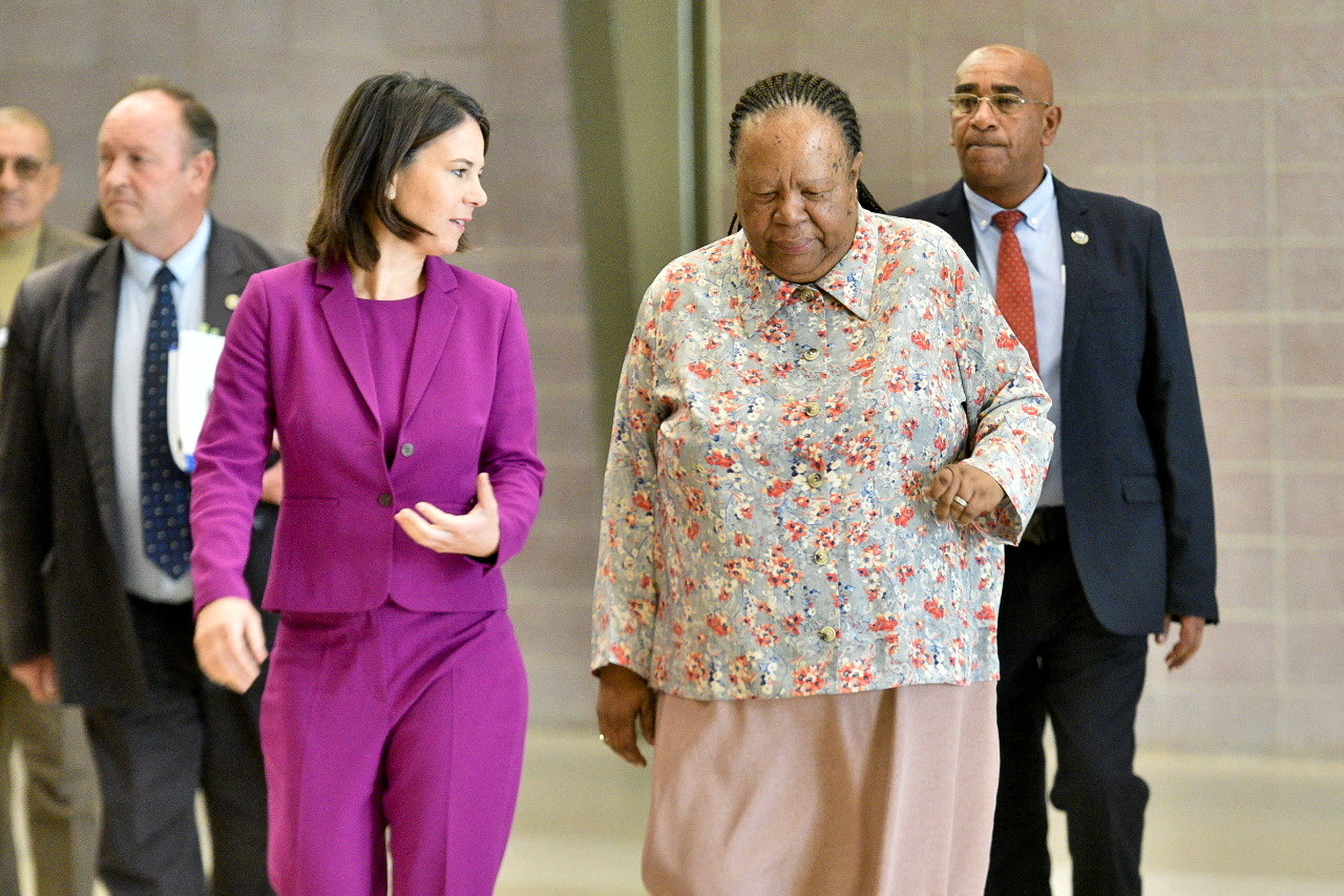 Germany's Foreign Minister Annalena Baerbock walks with South Africa's Foreign Minister Naledi Pandor, ahead of the South Africa-Germany Bi-National Commission in Pretoria, South Africa