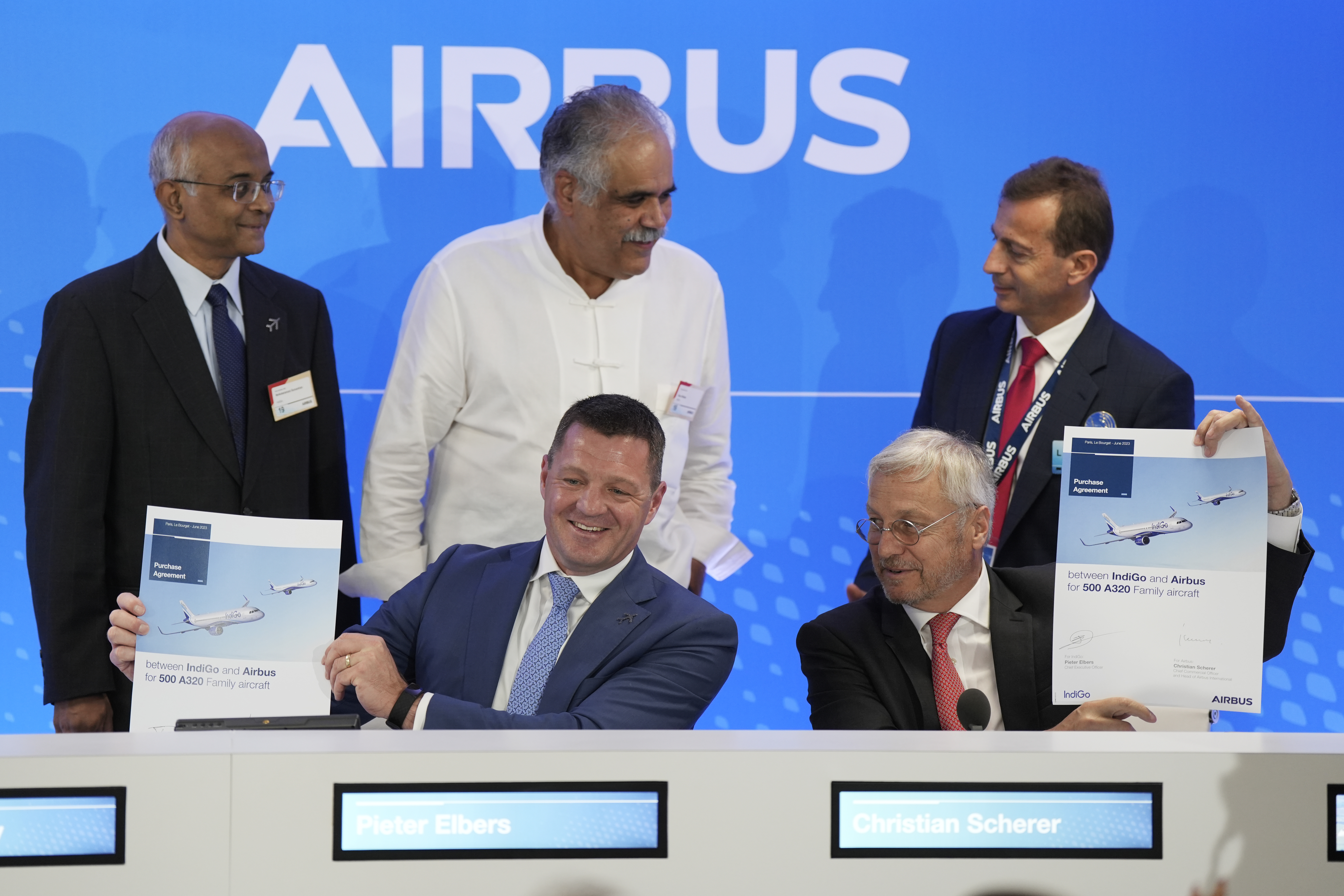 CEO of IndiGo Pieter Elbers, bottom left, Airbus Chief Commercial Officer and Head of International Christian Scherer, borrom right, Chairman and Non-Executive Independent Director of IndiGo Dr. Venkataramani Sumantran, left, Promoter &amp; Managing Director of IndiGo Rahul Bhatia, centre, and Airbus CEO Guillaume Faury pose for a picture with signed documents during a news conference during the Paris Air Show