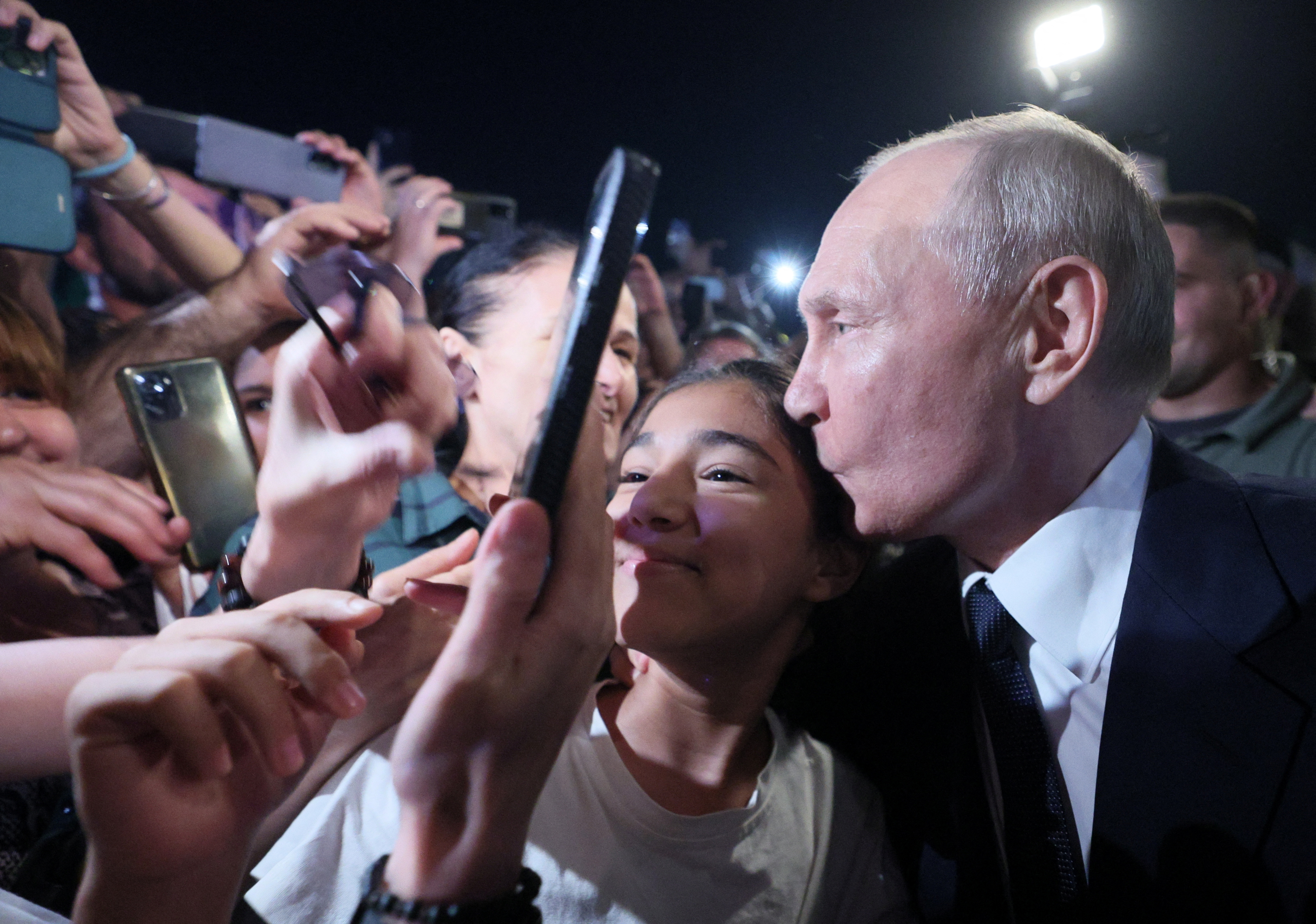 Russian President Vladimir Putin kisses a participant of a meeting in a street in Derbent in the southern region of Dagestan, Russia, June 28, 2023. Sputnik/Gavriil Grigorov/Kremlin via REUTERS ATTENTION EDITORS - THIS IMAGE WAS PROVIDED BY A THIRD PARTY.