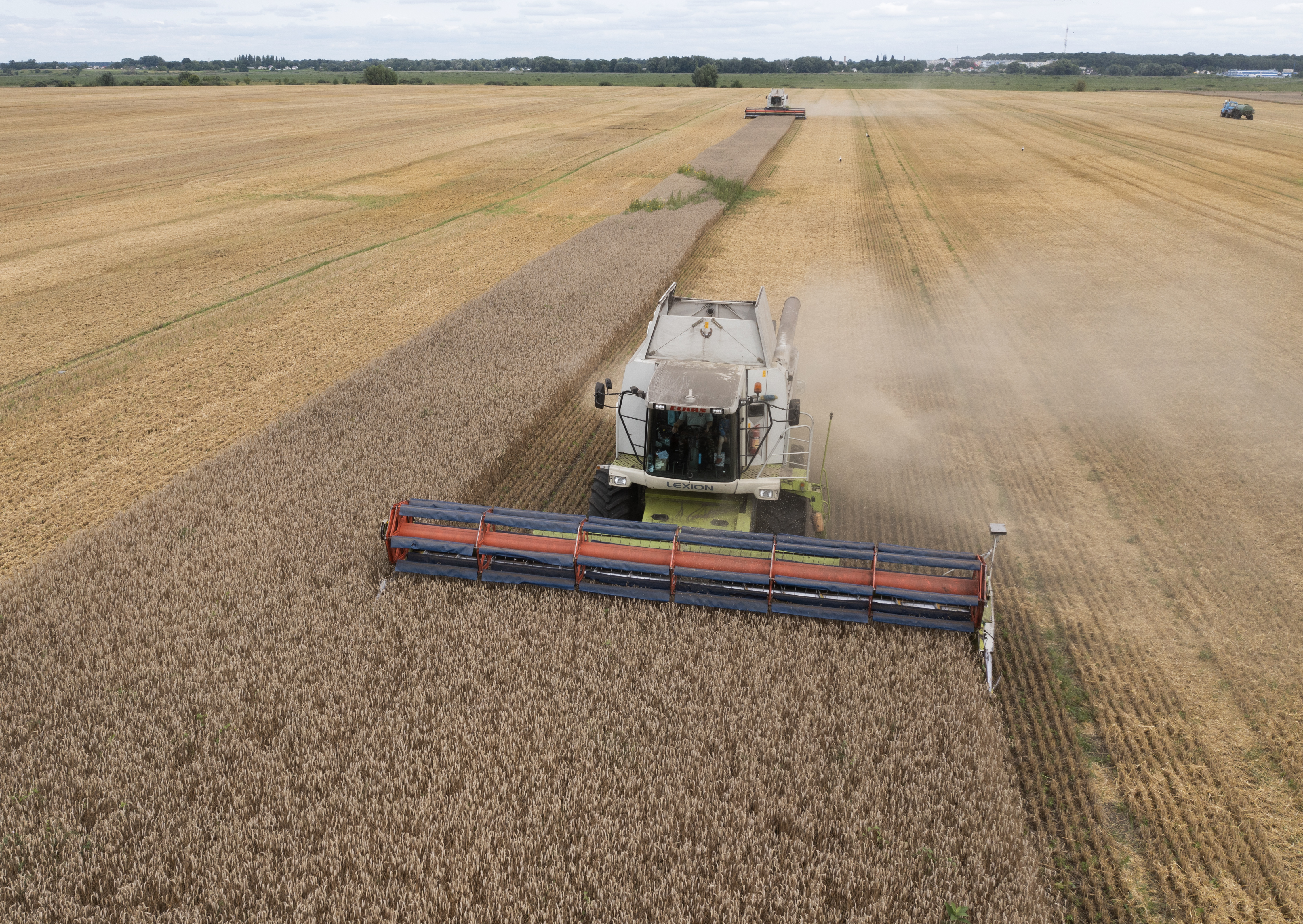 Harvesters collect wheat in the village of Zghurivka, Ukraine