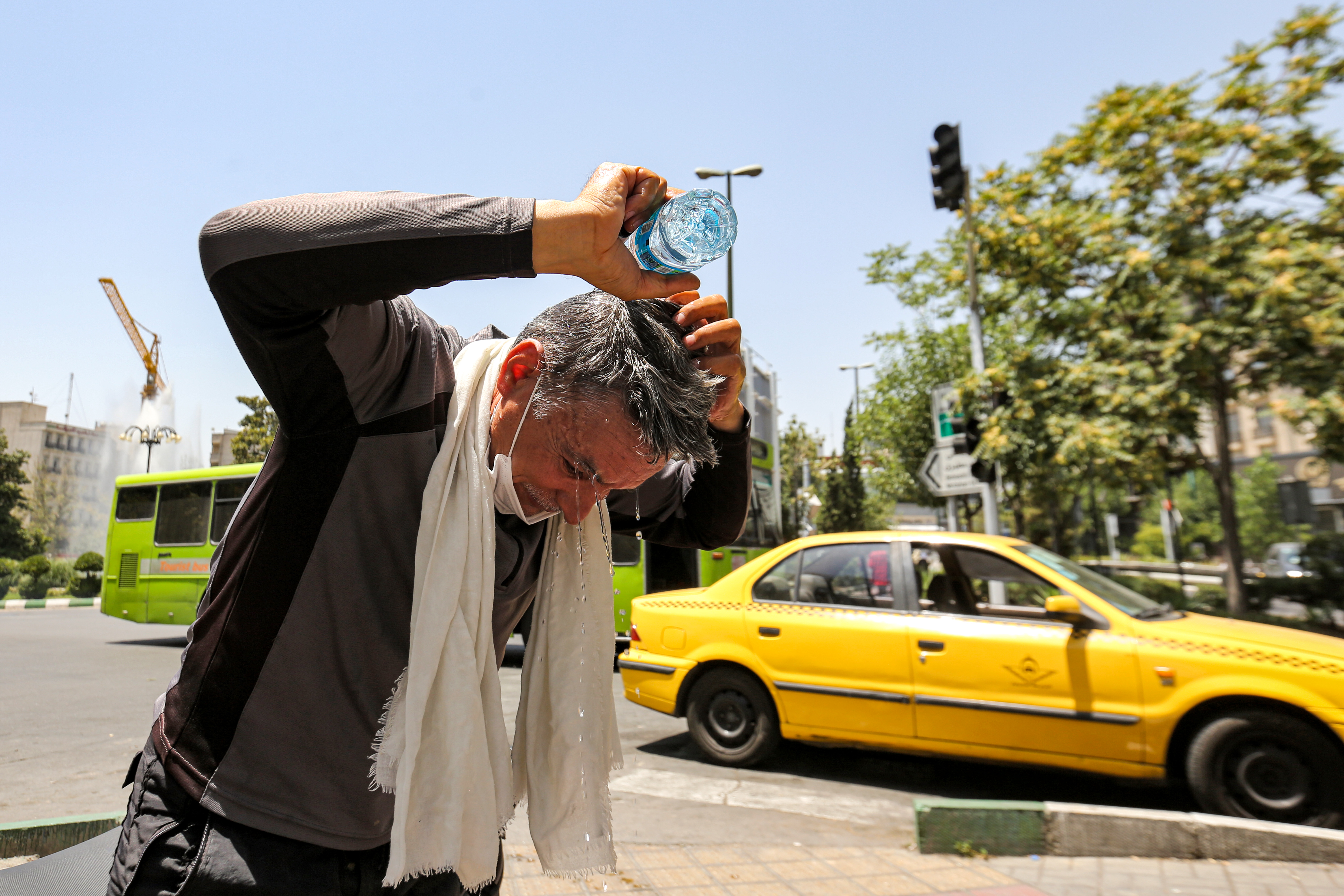A man attempts to cool off during a heatwave in Iran&#039;s capital Tehran [File: Atta Kenare/AFP]