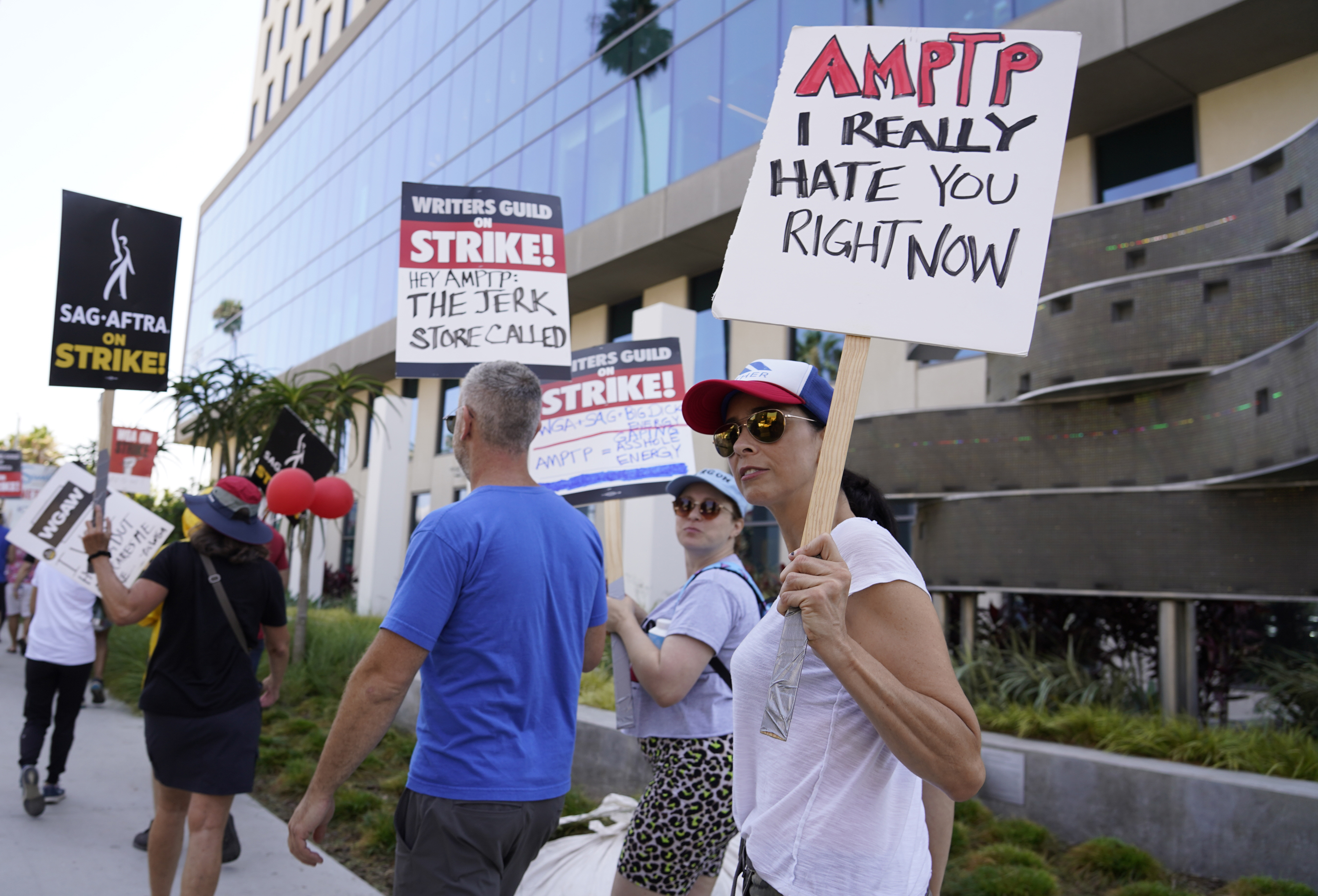 Sarah Silverman, right, walks on a picket line outside Netflix studios on Monday, Aug. 14, 2023, in Los Angeles. The Hollywood writers strike passed the 100-day mark as the film and television industries remain paralyzed by dual actors and screenwriters strikes. (AP Photo/Chris Pizzello)