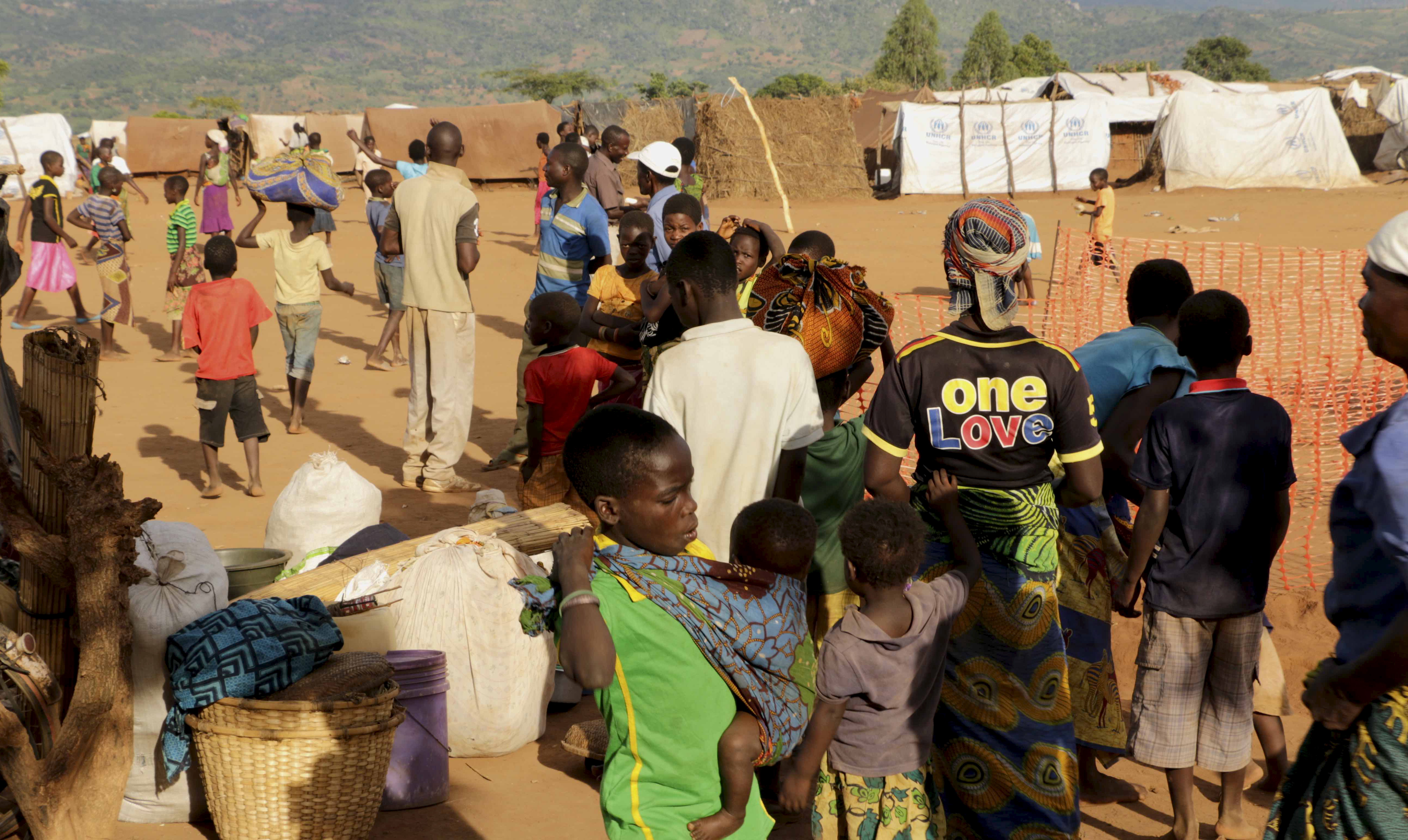 Mozambican refugees wait for registration at Kapise camp in Malawi's Mwanza district January 18, 2016. Thousands of Mozambicans have fled across the border to refugee camps in Malawi in the last month, saying Mozambique's Frelimo government forces are burning homes and killing civilians in a campaign against Renamo guerrillas in an escalation of a simmering conflict between old civil war foes. Spokesmen for both Frelimo and Renamo each told Reuters that the other side was responsible for attacks on their members in various parts of the country but would not give details about the violence that prompted the refugee exodus. REUTERS/Eldson Chagara